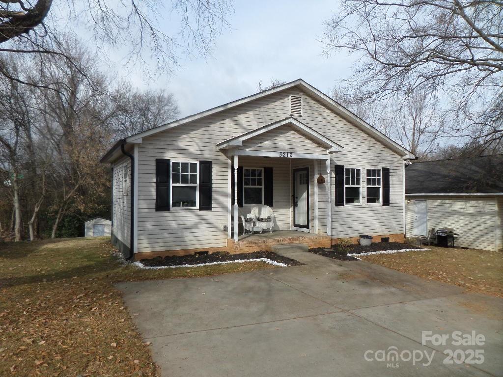 Owner-occupants only!  MOVE-IN READY! Cute 3 BR/1.5 Uptown bungalow with a large front porch and new landscaping.  Upgraded interior with trendy fixtures, laminate flooring, fresh paint, and new doors!  Open floor plan with galley kitchen, stainless steel appliances, and lots of natural light shining in.  Located at the end of a street with no through traffic, the home has a peaceful cul-de-sac feel.  Neat porch off of primary bedroom to take in the wooded back yard.  New gutters installed and features a backyard shed for additional storage.  Habitat for Humanity has first right to buy the home (they have declined prior to listing) and it is deed-restricted to owner-occupants only until 2030 (no investors can buy it until then).  Great, move-in ready affordable home opportunity for owner-occupants in a high potential Charlotte growth area- must see!