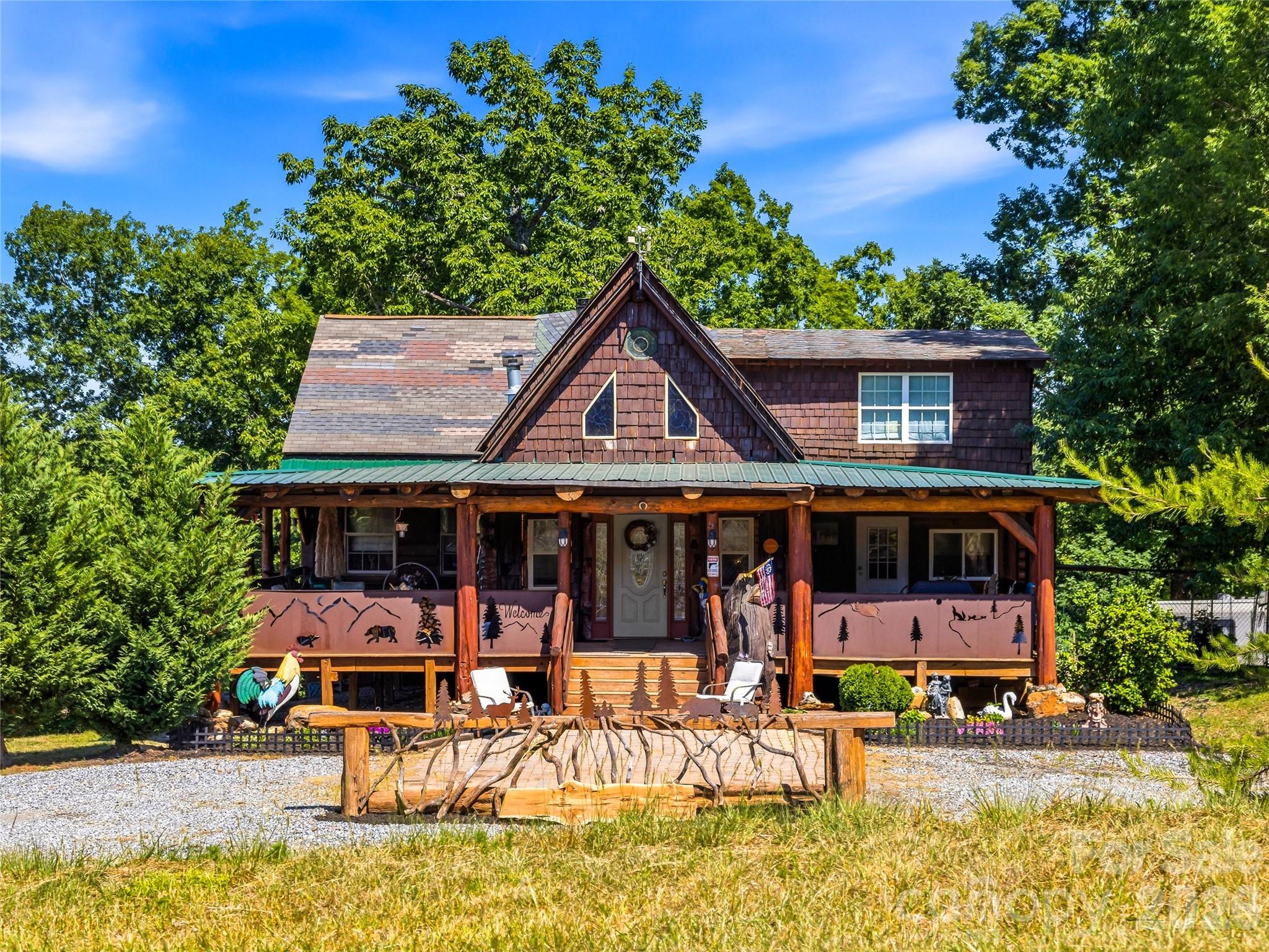 Few mountain properties offer the story, flexibility, and possibilities found on this 10-acre retreat  just minutes from downtown Rutherfordton, less than 20 miles from Lake Lure and Chimney Rock State Park, and about an hour from Asheville.  The custom-built 3-bedroom, 2.5-bath log cabin was handcrafted from timber milled directly from the property, creating a home rich in character with exposed wood beams, custom details, and thoughtfully designed living spaces.  

In addition to the main home, the property includes a 2-bedroom, 1-bath guest cabin currently operating as a short-term rental, a second cabin under development, and multiple additional homesites—ideal for a family compound, retreat, or expanded rental opportunity. Enjoy a stocked fishing pond, peaceful waterfall with a meditation area, creek, gem mine replica, mountain views, and wooded privacy. 

The hangar provides a unique opportunity for aviation enthusiasts to store their aircraft, while equestrian buyers may envision converting the space into a barn to complement the property's proximity to the Tryon International Equestrian Center, located less than 10 miles away. Further down the property, you'll find far more than a typical garage: Moonshiner's Garage is a destination of its own—offering a vehicle lift, generous workshop space, and plenty of room for collectors, hobbyists, and automotive enthusiasts.  

Whether you're looking for a mountain retreat, aviation property, income-producing investment, or legacy estate, 1002 C C Road is a rare opportunity unlike any other.