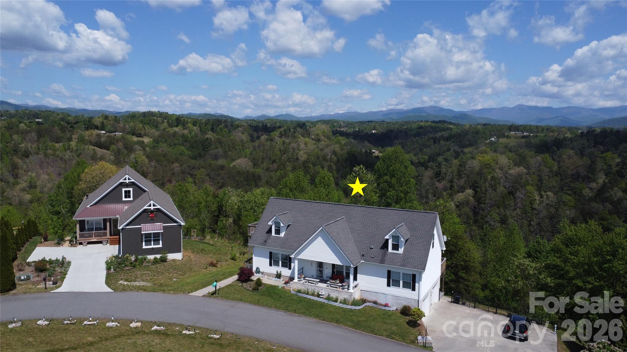 Nestled in the scenic beauty of Mars Hill, NC, this charming home offers a peaceful retreat surrounded by nature and breathtaking mountain views. Enjoy stunning sunrises and sunsets from your own property, with a quiet neighborhood that enhances the sense of privacy and tranquility. From the back of the home, take in views of a lush forest and Mount Mitchell, adding to the property’s unique appeal. Conveniently located less than 10 minutes from downtown Weaverville and the new AdventHealth Weaverville site, this home offers the perfect balance of seclusion and accessibility.