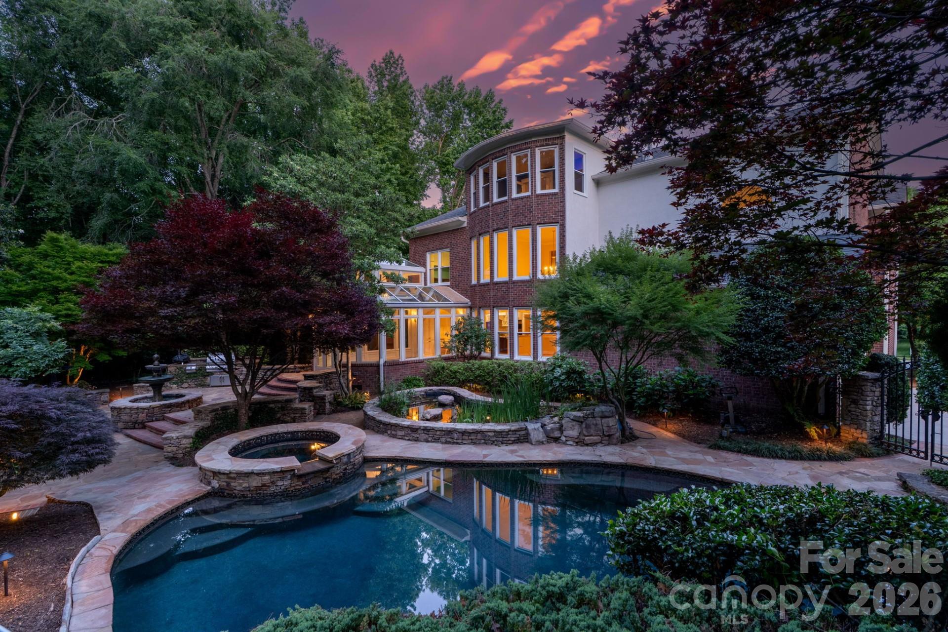 The Whitney Sanctuary — a 1.26-acre two-parcel legacy compound conveying under a single deed. The full-brick John Wieland Whitney offers 5,204 sq ft plus a 250 sq ft heated/cooled sunroom studio: 6 bed / 5 bath, 3-car garage, Wolf/SubZero culinary suite, heated marble primary ensuite, and in-ground pool with hot tub. 2025-
2026 renewals: new architectural roof, HVAC, full window and entry door package, 6-inch gutters, crawlspace vapor barrier, pool heater, salt cell, and filters, plumbing/electrical, full landscaping and lighting. Seller pre-inspection complete; all findings resolved. The 0.784- acre rear parcel is non-HOA under Town of Marvin zoning, featuring a Japanese walking garden, hand-laid bridge over a year-round private creek, chicken coop, and a 150 sq ft
Heritage Cabin painstakingly reassembled from reclaimed timbers with live power — ideal detached office, workshop, or guest retreat. Both parcels convey under Deed Book 8351,
Page 858