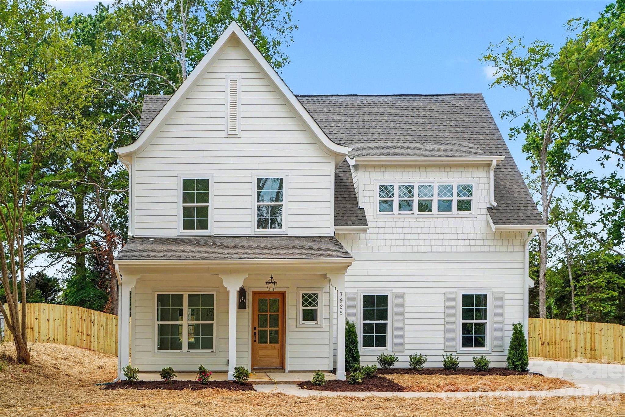 Mint Hill Custom without the wait! Welcome to 7925 Large Oak Ln, a charming 4 bedroom, 2.5 bath home tucked on a quiet side street in desirable Mint Hill. Thoughtfully designed with stylish finishes throughout, this home blends comfort with English country cottage-inspired charm, featuring designer tile, marble accents, upgraded lighting fixtures, and warm custom details throughout.

The bright open floorplan centers around a spacious kitchen with an oversized island, perfect for gathering, entertaining, or casual mornings at home. Coffee lovers will appreciate the dedicated coffee bar area with space for larger espresso or specialty machines. Generous living spaces and four well-sized bedrooms offer flexibility for guests, office space, or growing households.

Enjoy relaxing mornings on the covered front porch and unwind out back on the covered rear porch overlooking the fenced backyard—ideal for pets, play, or outdoor entertaining.

Located just a short stroll to Veterans Memorial Park and close to downtown Mint Hill shops, dining, and community events. A move-in ready gem with custom style, timeless character, and small-town charm.