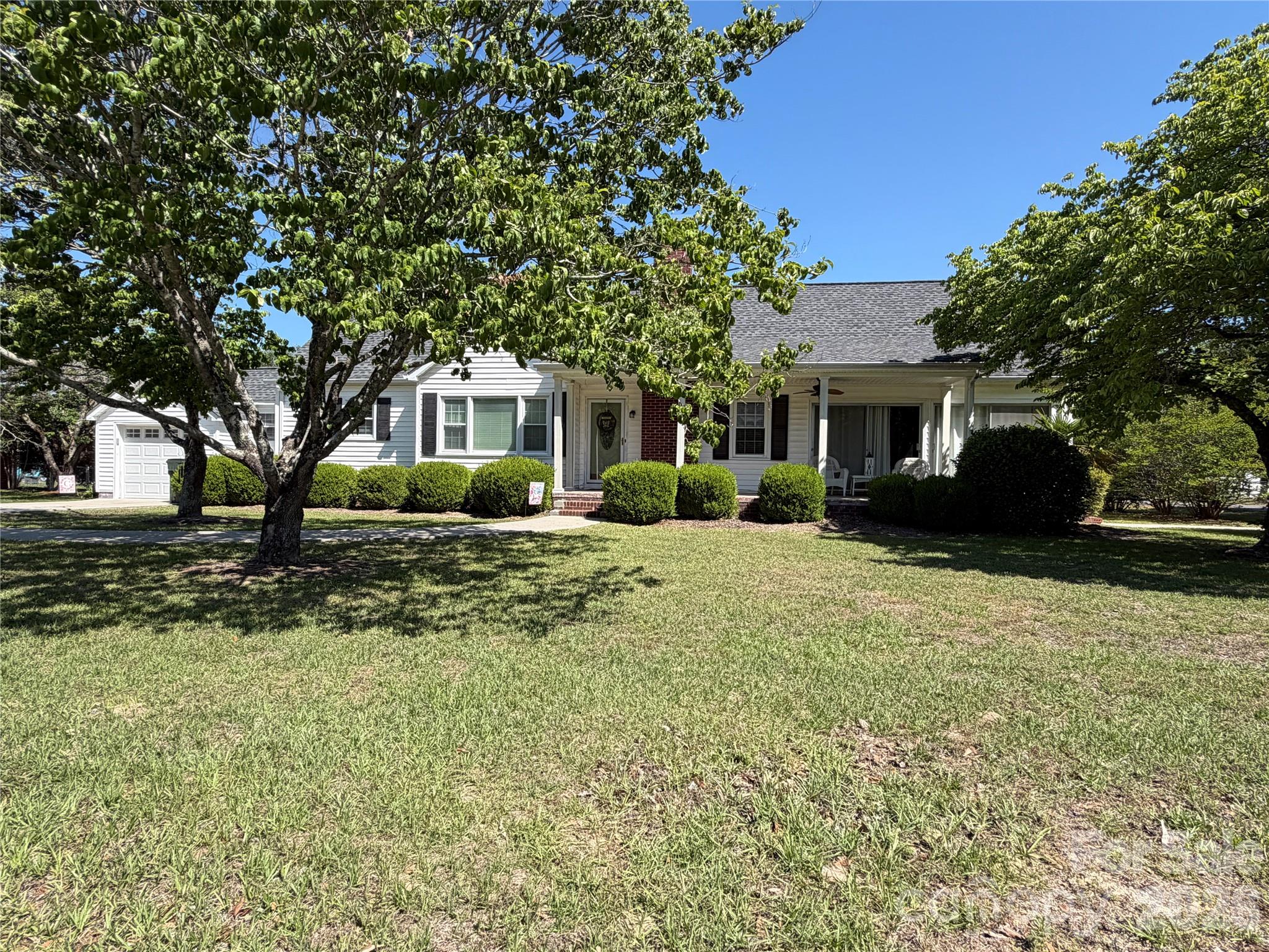 This charming and beautifully maintained 1950s home is situated on a spacious corner lot in the heart of Kershaw, SC. With close to 1800 sf of living space, this 4 bedroom 2 full bath home features hardwood and tile flooring, spacious kitchen with island and pantry, bright corner sunroom and a cozy den with fireplace. The main bedroom features a private full bath with 3 additional bedrooms and an additional full bath. Enjoy outdoor living from the covered front porch overlooking mature landscaping and a private back yard bordered by natural hedges. A one car garage is connected by an enclosed porch housing the laundry area, providing convenient access to the garage and back yard area. If you are looking for an older, well maintained home, this is one you do not want to pass up. This home is conveniently located to the amenities of Kershaw and within reasonable proximity to Lancaster, Camden, Columbia and Charlotte.