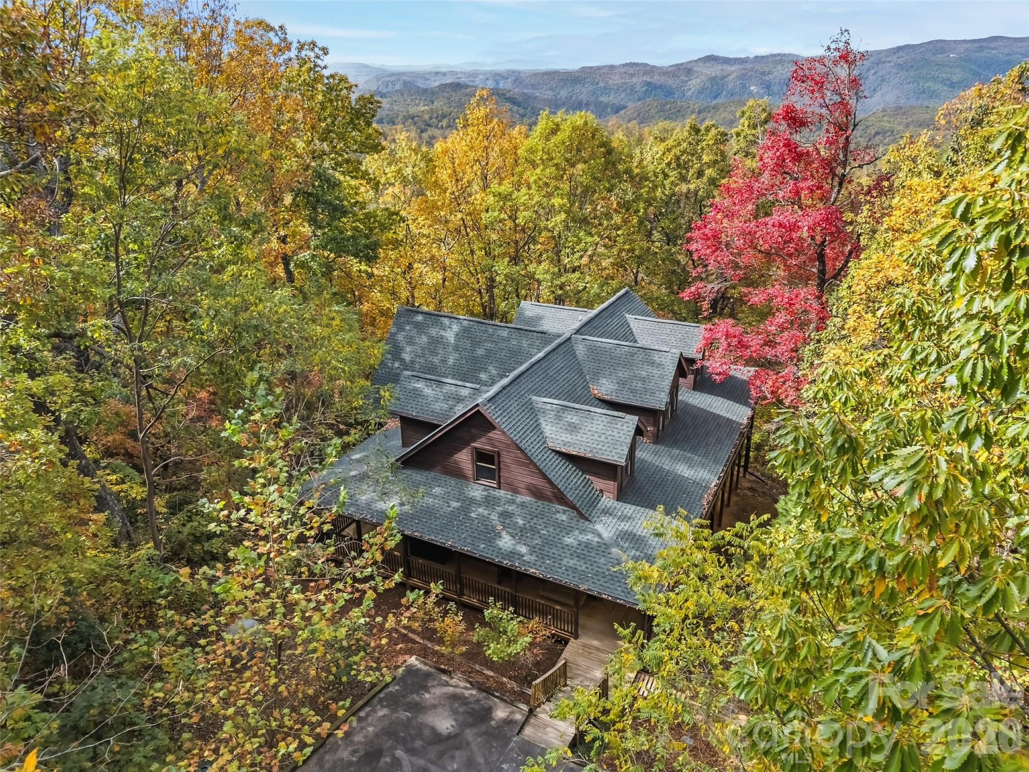 Whether you are looking for a dream mountain getaway or a great investment property, you will love this beautifully crafted owner-built log home nestled in a peaceful wooded setting only 16 minutes from downtown Saluda. A cherished retreat shared with loved ones, this home is designed for comfort, connection, and relaxation.

Enjoy stunning mountain views from multiple gathering spaces — perfect for entertaining or quiet reflection. Each guest enjoys a private retreat, while the spacious common areas invite everyone together for games, movies in the home theater, cozy evenings by one of two fireplaces, or a soak in the hot tub with views from the wraparound deck.

Quality construction, including superior system foundation walls, and thoughtful details are evident throughout. Most furnishings convey, making this an easy turnkey getaway. Short Term Rental is allowed and this home would be a great income producer. A whole-house generator and propane tank are included for added peace of mind.

The current owners chose to preserve the surrounding trees for privacy and serenity — but with selective clearing, this home could showcase breathtaking year-round, million-dollar views. An adjacent lot is also available for those seeking additional space or investment potential.

Whether you’re looking for a private mountain escape, an investment or a welcoming home to share with friends and loved ones, this property offers warmth, beauty, and lasting memories in every season.