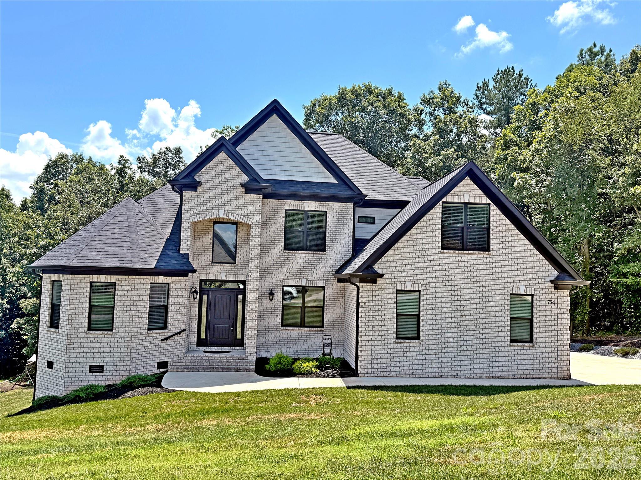 Welcome to this quality custom-built home in the prestigious River Bend community, a Lake Hickory neighborhood offering peaceful surroundings and convenient lake access. This exceptional 5-bedroom, 4-bath residence blends modern design with privacy and spacious living. The home features five private bedrooms—including two primary suites, one on the main level and one upstairs—each with an ensuite bath and walk-in closet. A dedicated office provides an ideal space for work or creative projects. The gourmet kitchen serves as the heart of the home, showcasing energy-efficient appliances, a large quartz-topped island with bar seating, custom maple cabinetry, a spacious pantry, and a separate breakfast area, all complemented by a formal dining room perfect for gatherings. The bright, welcoming foyer opens to a stunning living area highlighted by an 18' stacked-stone fireplace, hardwood floors, modern crystal lighting, and elegant finishes throughout. Outdoor living is equally inviting with a private backyard and a covered deck designed for year-round relaxation. High-end features include energy-efficient windows, an energy-efficient HVAC system, a water filtration system, central vacuum, video surveillance, and abundant storage. A 4-car driveway and 2-car garage provide ample parking and flexibility for hobbies or additional storage needs. Ideally located in a quiet, well-established neighborhood, this home offers easy access to shopping, dining, and top-rated schools, making it the perfect blend of convenience and tranquility. Don’t miss the opportunity to make this exceptional River Bend property your forever home.

Sellers are offering 1% of Purchase Price towards Buyers' Closing Costs with an acceptable offer.
