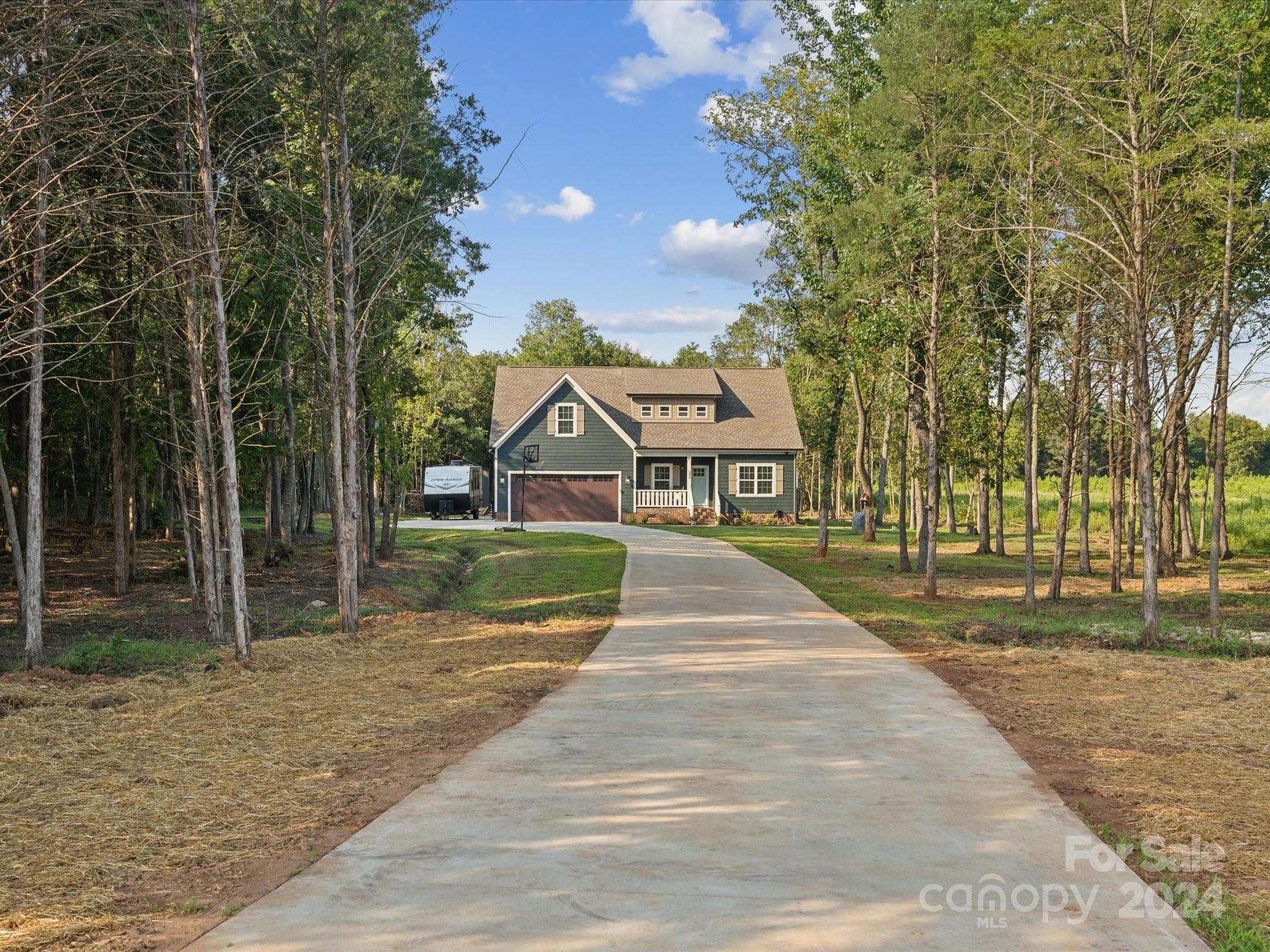 Stunning 4-bedroom home on 3+ acres in Rock Hill. Built only 2 years ago, this gorgeous home is full of custom details: decorative molding throughout, an oversized fireplace, upgraded lighting, a designer kitchen w/ granite countertops, SS appliances, and a decorative backsplash. Experience soaring ceilings in the 2-story great room, kitchen, and dining spaces! Downstairs, the large primary suite awaits w/ dual vanities and a walk-in closet, plus 2 additional bedrooms, a full bath, and the laundry room. Upstairs is the 4th bedroom, 3rd full bath, and an oversized bonus room that can be used as a 5th bedroom, home office, or bonus living space! Outside, enjoy a covered porch, patio w/ fire pit, and the sprawling 3+ acres of property, partially cleared and partially wooded for privacy with a newly designed trail system for ATVs. This home is in the perfect location for outdoor enthusiasts - just across the street from South Street Wake Park and a few minutes from Rock Hill Country Club.