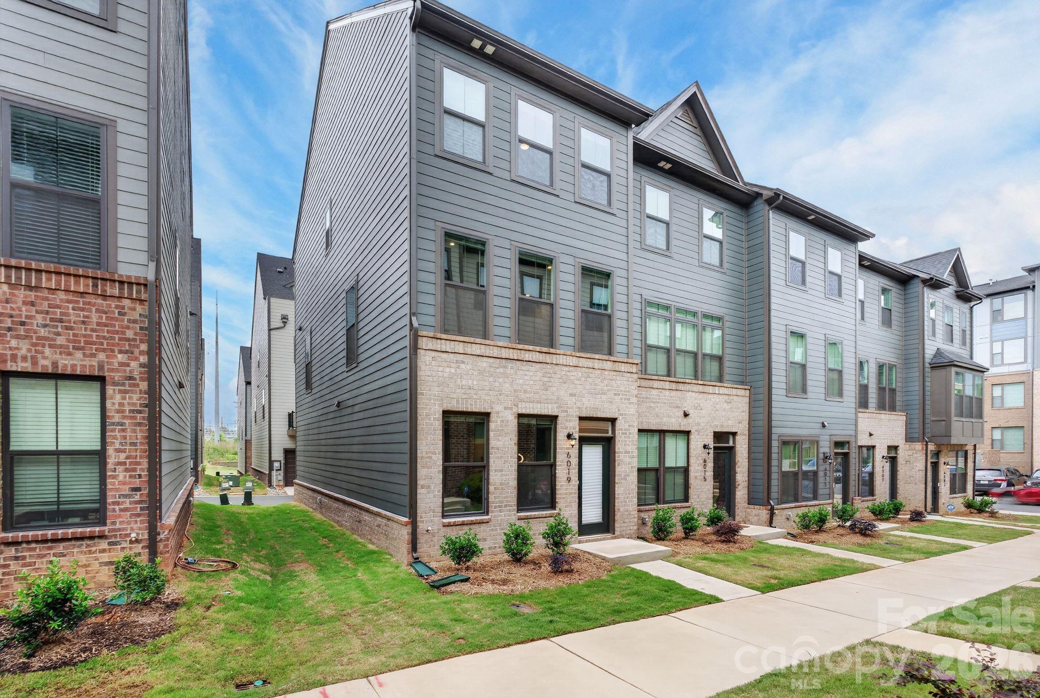 Welcome to a beautifully designed 3-bedroom, 3.5-bath end unit townhome in the highly sought-after Southrail Station community in Charlotte’s booming LoSo/South End area. Built in 2025, this modern residence offers approximately 1,600 square feet of stylish, low-maintenance living with a functional three-level layout designed for today’s lifestyle. The main level features an open-concept living, dining, and kitchen area filled with natural light, creating the perfect space for entertaining or everyday living. The sleek kitchen offers contemporary finishes, ample cabinetry, and an island overlooking the spacious living area and a back deck, ideal for morning coffee or evening relaxation outside. A convenient half bath completes the main level. Upstairs, you’ll find two spacious bedrooms, each with its own full bathroom, along with upper-level laundry for added convenience. The entry level provides exceptional flexibility with a private third bedroom and full bath, perfect for guests, home office, or fitness space. An attached garage adds secure parking and additional storage. Located just minutes from South End, Uptown Charlotte, the Rail Trail, breweries, restaurants, coffee shops, fitness studios, and the LYNX Blue Line light rail, Southrail Station offers the perfect blend of urban convenience and modern comfort. Enjoy quick access to some of Charlotte’s most popular destinations, nightlife, dining, and entertainment while living in one of the city’s fastest-growing neighborhoods.