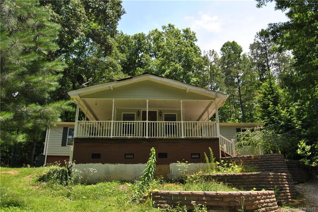 Wooded 6.95 acres provides a peaceful and private setting. Beautiful azaleas, rhododendrons, magnolia trees, and a variety of plants make for a wonderful view. The hand created stone pond adds to the character of the garden! Covered front porch, screened in back porch and deck perfect tons of great outdoor space. Great potential needs lots of TLC! Sold AS-IS.