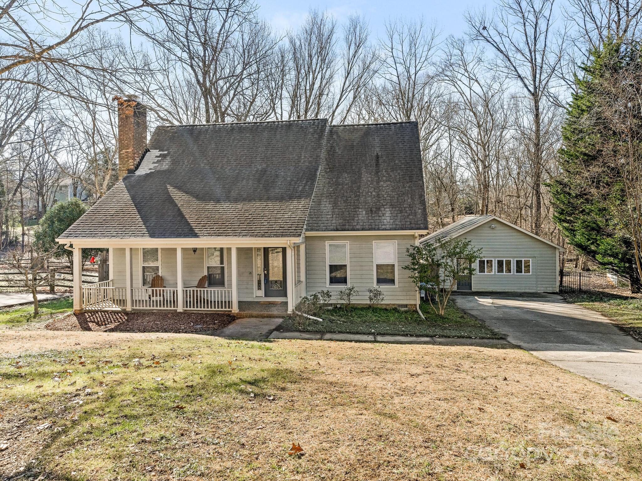 Charming 1.5 story home w/rocking chair front porch & access to McMullen Creek Parkway in your own back yard!! Primary bedroom on main features hardwood floors & WIC. Custom ensuite bathroom offers tile floors, dual vanity w/solid surface counters, white cabinetry w/abundant storage & jetted garden tub/shower. Spacious living room/dining room combo features beautiful hardwood floors. Updated kitchen boasts stainless appliances, tile backsplash, white cabinets, granite counters & lovely bay window overlooking back yard. Inviting screen porch & deck area overlook flat, private back yard. Large secondary bedrooms up offer abundant closet space & walk-in attic storage. Hardwood floors throughout upstairs & flex space could be a study or reading nook. Upstairs bathroom offers tub/shower combo, tile floors & single vanity. Gas water heater replaced 6/2024. Sump pump & french drain added recently. Refrigerator, washer/dryer convey! Easy access to shopping, great schools, restaurants & I-485!