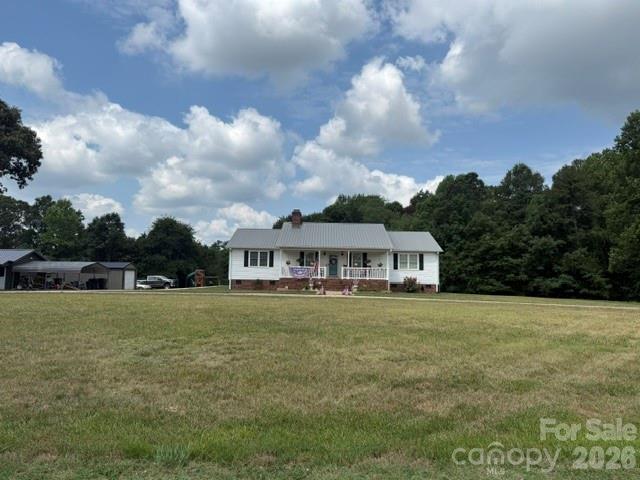 Welcome to 225 Westlee Street.  This home features 8.45 acres approximately and on the left side of the property you will find a creek.  It is a split bedroom plan and has many recent updates from flooring to bathroom remodels.  There is a sunroom also with tile floors and bamboo flooring adorns some of the rooms along with hardwood flooring.  The rock fireplace has gas logs and there is a tankless hot water heater that is gas also.  The home and approximately 3 acres are in the city limits of Lattimore but the additional land is not at this time.  The kitchen has granite and solid surface counters.  There is a range plus built in oven.  There is a circular drive in front along with 2 outside storage buildings that remain.  The roof is a metal roof.  The crawlspace has been encapsulated.  There is an option to hook on to Lattimore sewer but the home is currently on a septic tank.  The mobile home will be moved from the property and there is also a 3 bedroom septic tank there for that home.