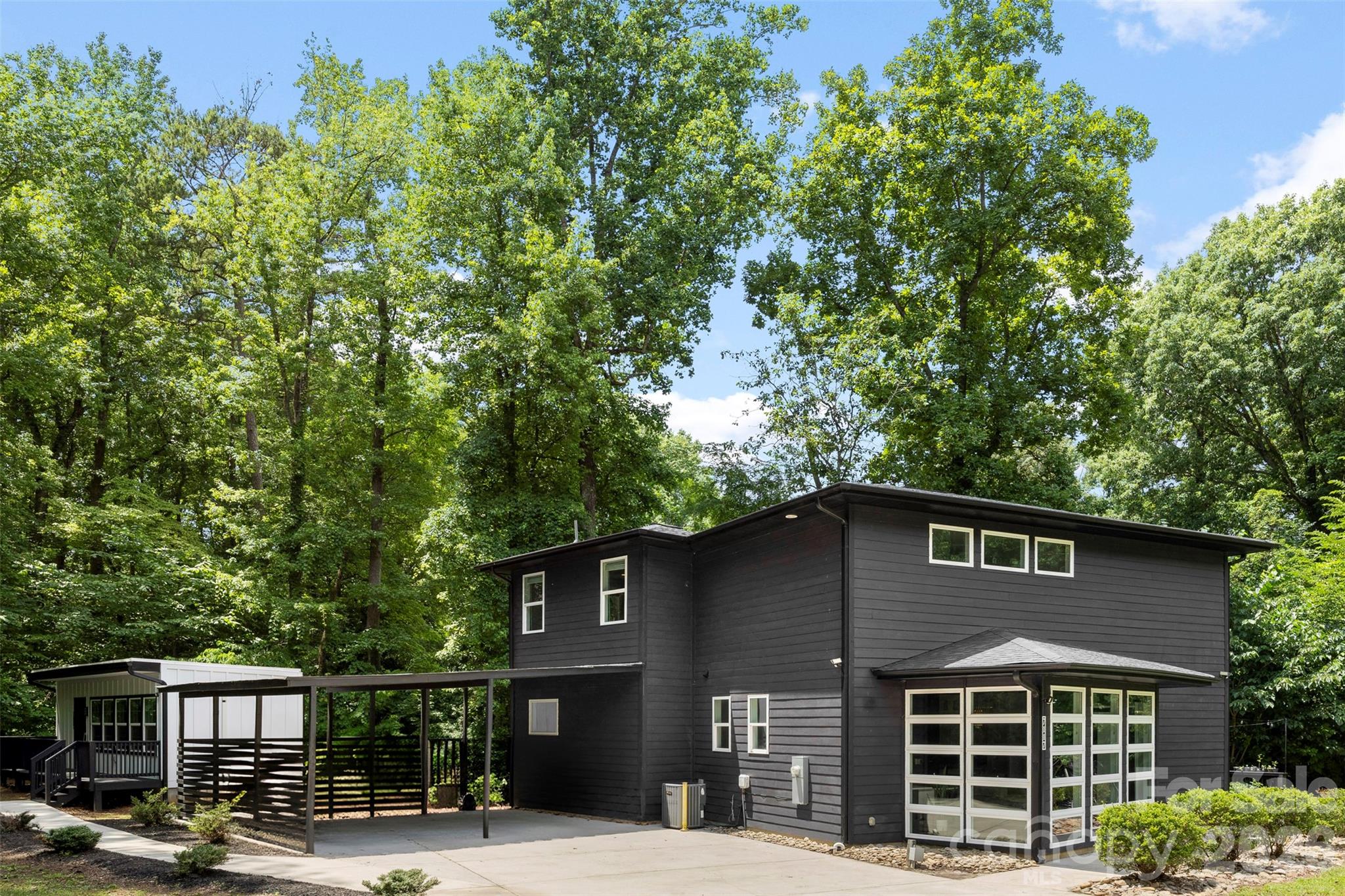 Welcome to 7117 W Sugar Creek Road, a rare opportunity offering flexibility, functionality, and modern living all on one property. Built in 2020 and situated on nearly half an acre, this unique property features a beautifully maintained 2-bedroom, 2.5-bath main residence plus a detached Accessory Dwelling Unit (ADU), a highly sought after feature in today's market.

The main home offers an open-concept layout with modern finishes, spacious living areas, and abundant natural light. The thoughtfully designed floor plan includes two generously sized bedrooms, each providing comfort and privacy, along with three well-appointed bathrooms. The open living, dining, and kitchen areas create an inviting atmosphere perfect for both everyday living and entertaining.

Adding exceptional value, the detached ADU provides endless possibilities. Whether you're seeking space for multigenerational living, a private guest suite, home office, creative studio, or potential rental income opportunity, this versatile space offers the flexibility to meet your needs.

Conveniently located with easy access to Uptown Charlotte, major highways, shopping, dining, and entertainment, this property combines the benefits of modern construction with the versatility today's buyers desire.

Whether you're an owner-occupant looking for extra space or an investor seeking income-producing potential, 7117 W Sugar Creek Road is a property that truly stands out. Schedule your showing today and discover all the possibilities this unique property has to offer.