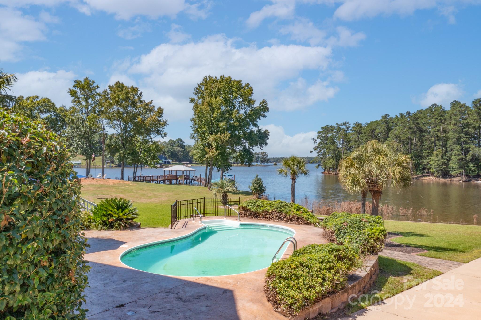 Looking for a house that has it all??Welcome to 2388 Lake Road! No detail has been missed on this beautiful waterfront home. There is plenty of space for everyone thanks to the upstairs bonus room and partially finished basement. The remainder of this large basement has high ceilings to store your toys or make it into your dream workshop. Speaking of storage, in addition to the attached two car garage there is an external boat garage that is heated and cooled making it perfect for a workshop, studio, or boat storage. It only gets better when you walk outside to your expansive yard boasting a flat lot with a private boat launch. No stairs required to get to your multi-boat covered dock with boat lift. After a day on the water enjoy a swim in your crystal-clear pool or hang out on the patio with built in firepit. The choices are endless in this unique home. Note Zillow posted taxes are based on ownership by a non SC resident. Property tax would be approximately half for  a SC resident.