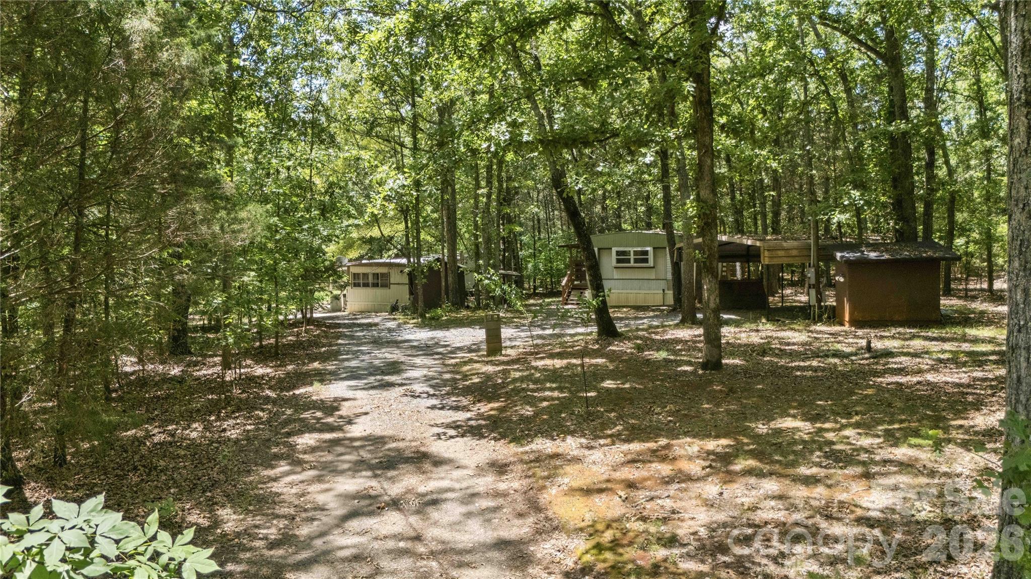 Rare opportunity to acquire 5.63 acres of versatile land with unlimited potential. This property currently features two existing 2-bedroom, 1-bathroom mobile homes, each offering a blank slate for those with a vision. Whether you are looking for a project to renovate, a strategic investment for rental income, or the ideal site for your custom-built dream home while you live on-site, this tract is ready for its next chapter. The property includes two covered carports and is already partially fenced on three sides, providing a solid foundation for your future plans. The true value here lies in the expansive acreage and the flexibility to create a private family compound or a development project. Bring your ideas and vision—this is a chance to build exactly what you want, where you want it.