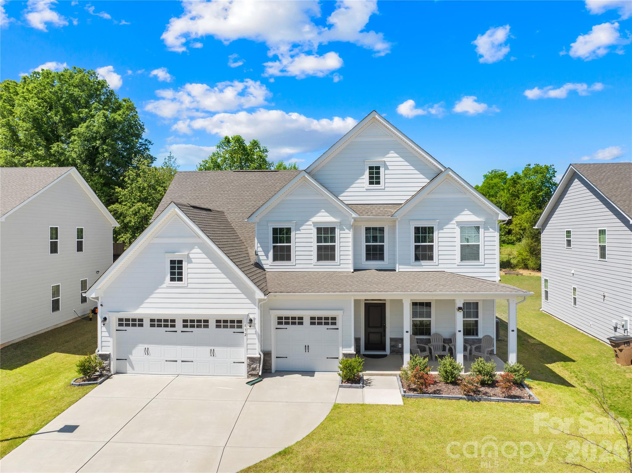 Move-in ready and like-new 2023-built home in the desirable Springshire Creek community, offering 3,378 square feet of thoughtfully designed living space with 5 bedrooms and 4 full baths, set on an approximately 0.25-acre lot with a private wooded backdrop.

From the moment you arrive, the inviting front porch and spacious 3-car front-entry garage—featuring a professionally finished epoxy floor—set the tone for a home that blends curb appeal with everyday functionality. Step inside to a modern, open layout designed for both comfortable living and effortless entertaining. A private office with glass French doors creates the perfect work-from-home retreat, while the main-level guest suite with a full bath offers flexibility for visitors or multi-generational living.

At the heart of the home, the expansive great room flows seamlessly into a beautifully appointed kitchen featuring quartz countertops, white cabinetry, tile backsplash, stainless steel appliances, a gas range with hood, a large island, and a walk-in pantry. The adjoining breakfast area is filled with natural light and opens toward the backyard, creating a seamless indoor-outdoor connection.

Upstairs, the primary suite offers a spacious private retreat complete with dual walk-in closets and a well-appointed bath, providing both comfort and functionality. The secondary layout is thoughtfully designed, with one bedroom featuring its own attached full bath, while the remaining two bedrooms share a full hallway bath. A versatile loft and a conveniently located laundry room complete the upper level, offering flexibility for everyday living.

Step outside into your own backyard retreat. A covered screened porch extends your living space year-round, while the extended concrete patio provides ample room for entertaining, dining, or simply relaxing while enjoying the peaceful wooded setting.

Located in a quiet suburban setting, this home offers access to community amenities including a dog park, picnic area, playground, and walking trails. Conveniently situated near Highway 74 and I-485, with easy access to shopping, dining, Atrium Health Union, and downtown Monroe, and a short drive to Charlotte.

Skip the construction delays and move-in ready stress—this like-new home is ready for you to enjoy from day one.