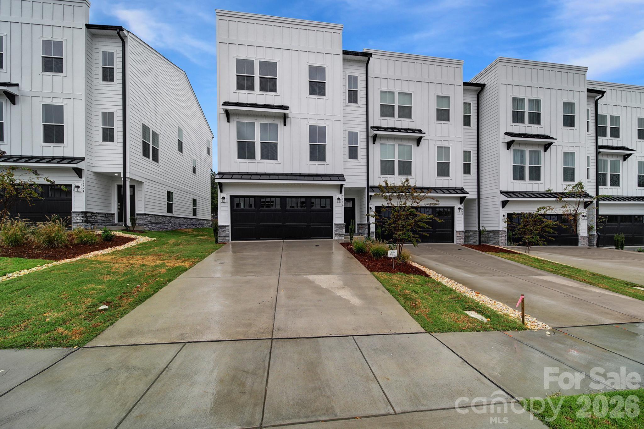 Located in a highly walkable community, this stunning home offers prime location living just steps from grocery stores, restaurants, medical offices, and everyday conveniences. Situated in the heart of a vibrant shopping, dining, and entertainment district, and surrounded by upscale homes, this property delivers the perfect blend of luxury, convenience, and lifestyle.

The main level features a bright open-concept floor plan with a spacious great room flowing seamlessly into the kitchen and dining area—ideal for modern living and entertaining. The gourmet kitchen is a true highlight, featuring a massive 10-foot island with seating for 4–5, walk-in pantry, and gas cooking—perfect for home chefs. The dining area opens to a private deck, creating effortless indoor-outdoor living.

Upstairs, the luxury owner’s suite offers a private retreat with dual walk-in closets, spa-like bathroom, dual vanities, a large walk-in shower with built-in seating, and a private water closet. Secondary bedrooms are generously sized and share a full bath, along with a convenient upstairs laundry room and linen storage.

The entry level includes a flex space / bonus room with a private en suite bath—ideal for a guest suite, home office, or multi-generational living.

Additional features include a two-car garage, private driveway
Enjoy community amenities including walking trails, green spaces, and playground, offering a true neighborhood lifestyle.

Located in a top-rated school district, zoned for Cox Mill Elementary, Harris Road Middle, and Cox Mill High School—making this an excellent choice for families, professionals, and relocation buyers.