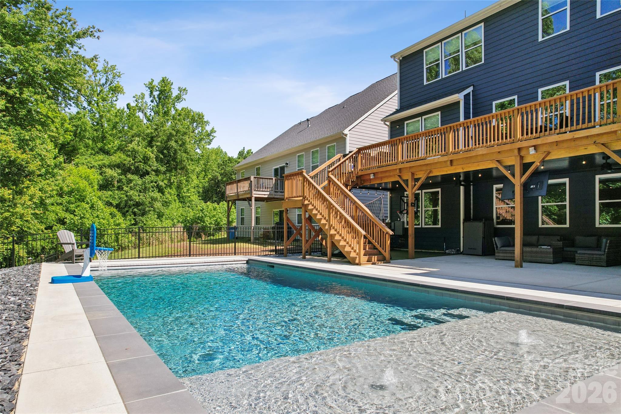 The one you have been waiting for! Stunning 2-story home with a fully finished walk-out basement featuring 6 bedrooms and 5 full bathrooms, perfectly positioned at the end of a cul-de-sac with no neighbors in front or behind for ultimate privacy. Enjoy direct access to the neighborhood trailhead entrance creating a peaceful setting. The gourmet chef’s kitchen features quartz countertops, a designer tile backsplash, butler’s pantry, under-cabinet lighting, stainless steel appliances, gas cook-top, and upgraded lighting. 
The spacious primary suite offers a true retreat with dual walk-in closets and a luxurious ensuite bath featuring separate his-and-her vanities, a large garden tub, and an oversized walk-in shower.
Guest suite on main level with full bath. 
Built for entertaining, the backyard showcases an incredible heated saltwater pool installed in September 2025 featuring a CoverMatic automatic pool cover with lock and key, over 30 feet in length, and an oversized 7’ x 15’ tanning ledge. The outdoor entertaining area includes a bar area, refrigerator, gas grill space and custom under-deck ceiling with built-in draining, allowing you to enjoy the outdoor rain or shine. This rare combination of luxury, privacy, and outdoor living is hard to find. Additional upgrades include a tankless water heater and separate HVAC units for each level — basement, main floor, and second floor — providing enhanced comfort and efficiency throughout the home. 
Prime Fort Mill location is just minutes from I-77, Charlotte, Ballantyne, and Uptown. Situated in a top-rated school district and close to shopping, dining, and parks. This amenity-rich community features a clubhouse, fitness center, playground, two outdoor pools, walking trails, paddle sport launch, Catawba River access, and so much more!