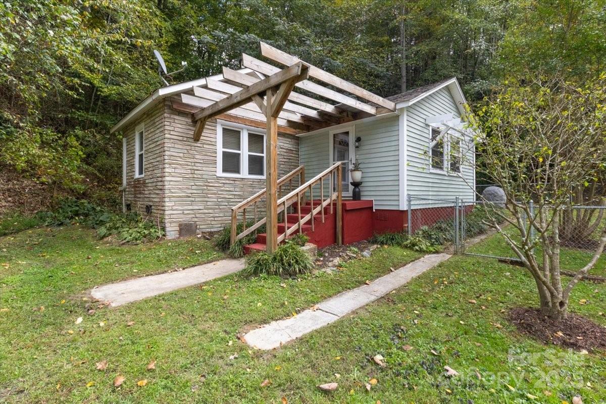 Discover peaceful country living just 5 miles from Hot Springs and the Appalachain Trail and 10 miles from Marshall with easy access to Asheville. This home is perfect for first time home owners, a rental or second home in the mountains. This charming bungalow offers many recent updates. New electrical box, plumbing and hot water heater installed in 2024. This home has beautiful wood floors, stainless appliances and a cozy gas log fireplace.