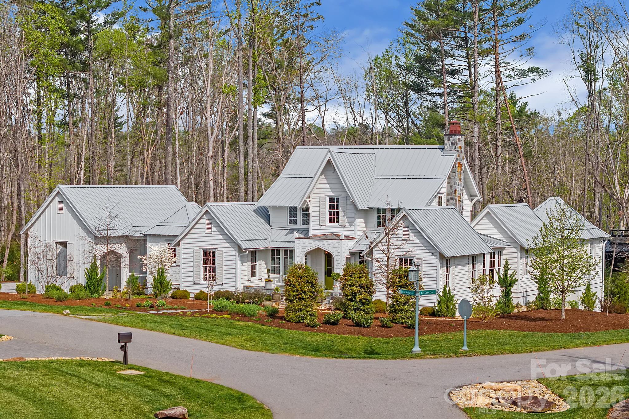 Tucked quietly within The Ramble Biltmore Forest, 97 Emerald Necklace is the 2020 Southern Living Idea Home, a one-of-a-kind residence envisioned by a nationally recognized team of architects, builders, and designers as a fresh expression of modern Southern living. Rooted in the timeless beauty of classic Southern architecture, the home pairs gabled rooflines, inviting porches, and balanced symmetry with a softer, more contemporary sensibility shaped by natural materials, abundant light, and a seamless connection to the landscape. Wide-plank white oak floors, hand-selected finishes, custom cabinetry, and richly layered textures create interiors that feel both refined and welcoming, while every space is designed with intention for gathering, retreating, and everyday living.

Large windows frame the surrounding landscape like art, and doors open effortlessly to porches and outdoor living spaces that blur the line between indoors and out. The additional double corner lot offers privacy from neighbors. The result is a home that feels alive to its setting, changing beautifully with the light, the seasons, and the rhythm of daily life. Beyond the home itself, The Ramble Biltmore Forest offers a rare sense of place, where preserved forests, walking trails, and thoughtfully protected natural beauty create an exceptional community experience. Southern Living Idea Homes are never duplicated and rarely offered, making 97 Emerald Necklace a truly special opportunity in one of Asheville’s most sought-after communities.