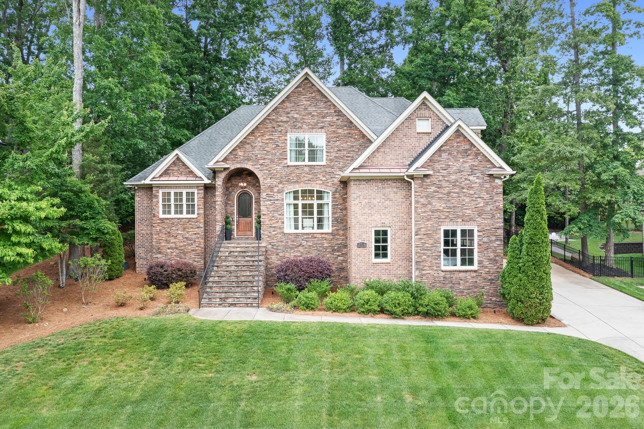 Seller is offering $10K in closing costs. Beautifully updated and impeccably maintained, this custom brick home offers timeless style and modern comfort just minutes from Cowans Ford Golf Club and Lake Norman. Offering over 3,100 square feet, this 4-bedroom, 2.5-bath home blends classic design with thoughtful modern updates. The recently remodeled kitchen is the heart of the home, featuring Taj Mahal quartzite countertops, soft-close cabinetry with built-ins, premium stainless steel appliances, designer lighting, and custom reeded glass pantry doors. The open layout flows seamlessly into the living area, highlighted by wide-plank hickory hardwoods, built-ins, and a stunning stacked stone fireplace. The main-level owner’s suite offers a refreshed retreat with a spa-inspired bath and walk-in closet, while a private office or optional fourth bedroom provides flexible living space. Additional spaces include a formal dining room, breakfast area, laundry room with custom drop zone, and an upper-level loft with an entertainment room featuring custom shelving, wet bar, and beverage refrigerator. Outdoor living is equally inviting with an extended deck overlooking a fully fenced yard, new sod, and curated landscaping—perfect for relaxing or entertaining. Energy-efficient upgrades include spray foam insulation, encapsulated crawlspace, and tankless water heater. Located in a sought-after golf and lake community, this immaculate home offers the perfect balance of comfort, style, and convenience just minutes from Lake Norman, shopping, dining, and recreation.