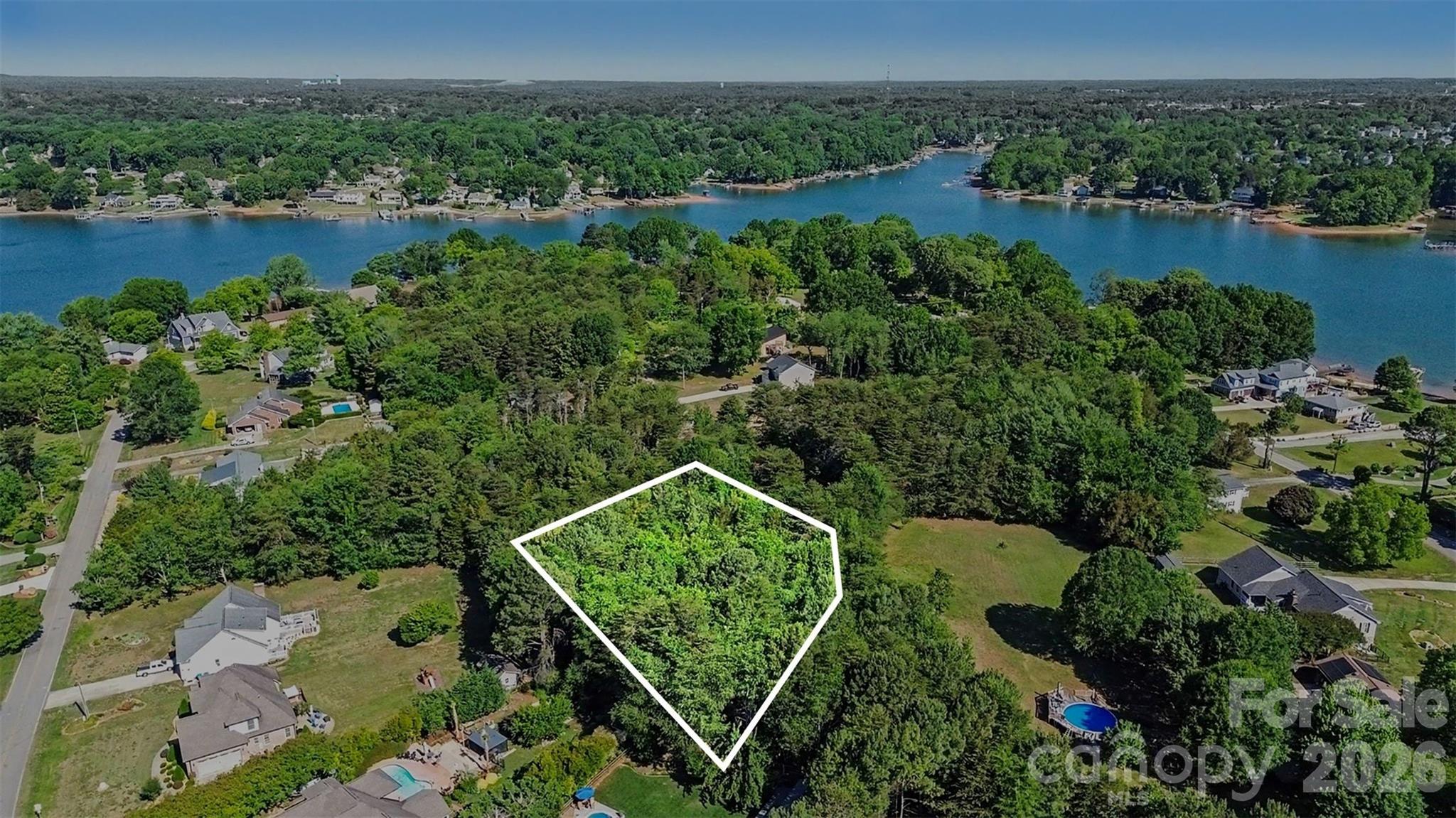 Rare opportunity to build your dream home on this private 0.54-acre cul-de-sac lot with NO HOA in the desirable Lake Norman area of Mooresville. Tucked away among mature trees and surrounded by waterfront homes, this wooded homesite offers the perfect combination of privacy, space, and location.

The lot is relatively flat and well-suited for a custom home build, with septic and well needed. Located within a waterfront community featuring marina and public water access nearby, this property is ideal for buyers wanting to enjoy the Lake Norman lifestyle without the high costs of direct waterfront ownership.

Conveniently located near marinas, restaurants, shopping, and I-77, all with low Iredell County taxes and zoned for highly rated schools. Whether you're looking to build now or invest for the future, this is a hard-to-find opportunity just off of beautiful Lake Normans's shore.