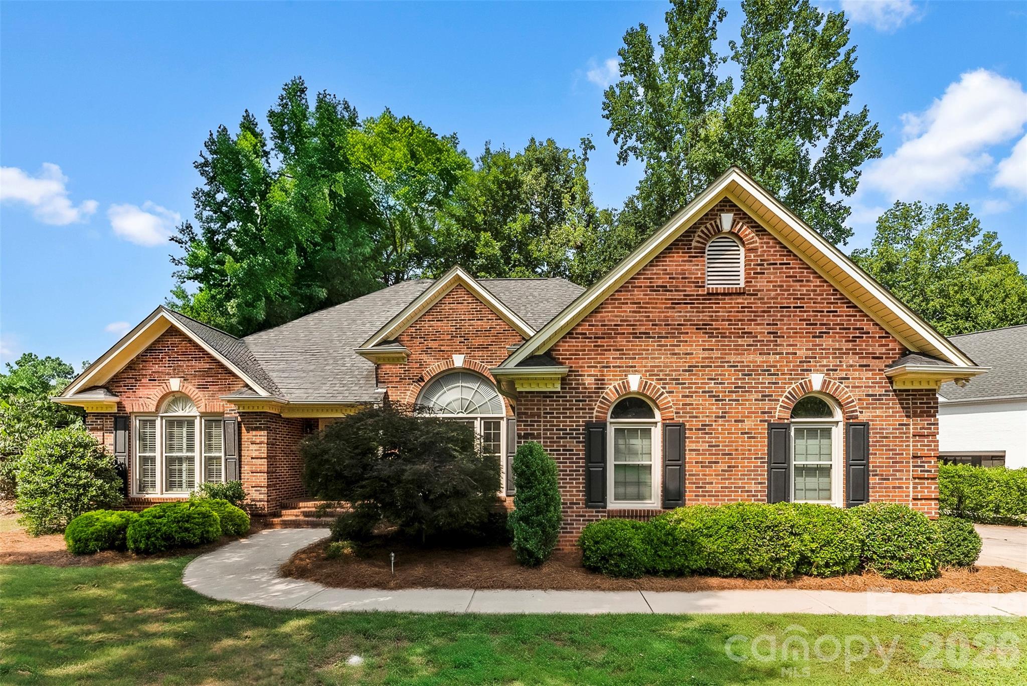 Perfectly situated on the 13th fairway of the prestigious Cramer Mountain Country Club, this beautiful one-story, full-brick home offers exceptional craftsmanship!

Inside, you'll immediately appreciate the bright, open floor plan featuring rich hardwood floors, a cozy gas log fireplace with custom built-ins, and an updated kitchen complete with granite countertops and a tile backsplash. The inviting sunroom offers panoramic views of the 13th fairway, creating the perfect space to enjoy your morning coffee or unwind at the end of the day while taking in the peaceful golf course setting.

Outside, one of the few level lots in Cramer Mountain showcases beautiful landscaping, irrigation, and a fenced backyard that's ideal for pets, play, or simply enjoying the outdoors. The oversized two-car garage offers ample space for large vehicles, a golf cart, and additional storage.

Residents enjoy the security and beauty of gated Cramer Mountain, with optional memberships available to the country club for golf, tennis, swimming, dining, and social events—allowing you to enjoy as much or as little of the club lifestyle as you choose.

Come experience the warmth of this exceptional home and discover why so many are proud to call Cramer Mountain home.