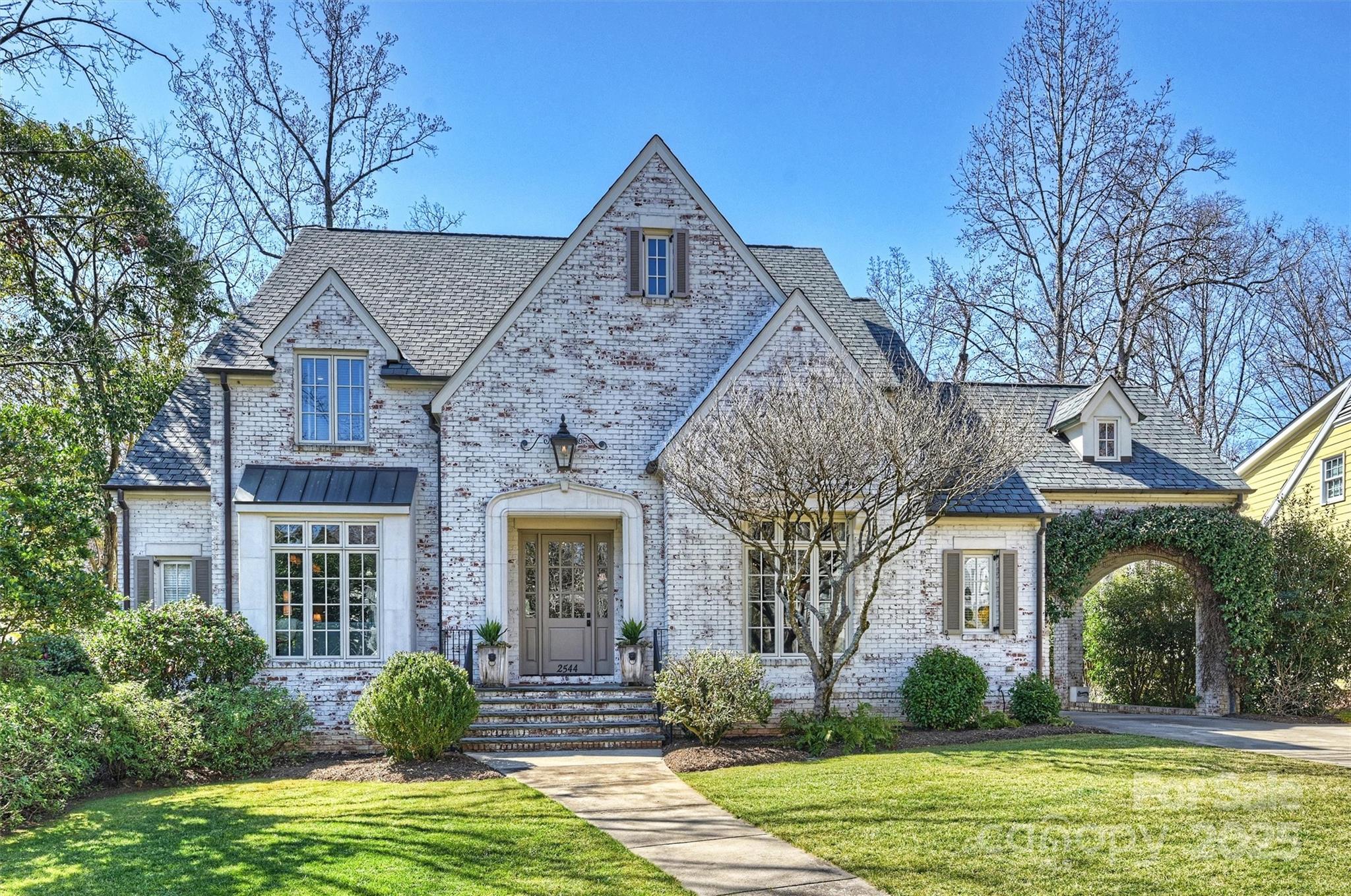 Nestled on a quiet street in the heart of Myers Park, this exquisite home blends classic architecture with modern luxury . The meticulously landscaped private yard offers a serene retreat, while the timeless design showcases detailed moldings, designer light fixtures, and 10’ ceilings. The gourmet kitchen/ keeping room features cabinetry of furniture-quality adorned in Calcutta Gold marble. The moody study and the lovely dining room that has butler's pantry provide formality while other spaces cater to everyday functionality, wants and needs. The primary suite, tucked away for privacy, boasts soaring ceilings and a spa-like bath. Four fireplaces add warmth and charm throughout. The family room seamlessly extends to a covered porch with retractable screens—perfect for indoor-outdoor living. The lower level offers a rec room, billiards room, exercise space, and a secluded guest suite. Abundant storage completes this exceptional home. Don’t miss this rare opportunity!
