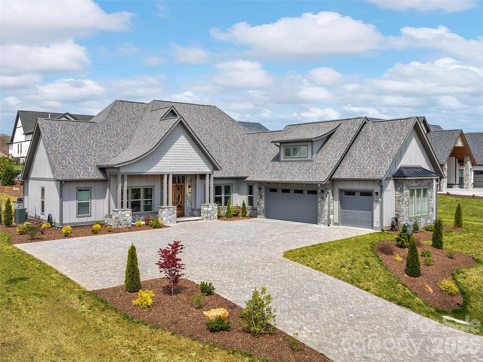 Luxury One-Level Living in Beautiful Mills River & Turnkey Elegance. Step into luxury with this practically brand-new, one-level masterpiece located in the highly sought-after Mills River. Designed with an exceptional split-bedroom floor plan, this home effortlessly balances sophisticated entertainment spaces with private, tranquil retreats. From the high-end custom built-ins to the top-of-the-line finishes throughout, no detail has been overlooked. At the heart of the home is a gourmet chef's kitchen, boasting premium cabinetry, a massive statement island, rich hardwood floors, and an expansive walk-in pantry. The kitchen flows seamlessly into the main living areas and a dedicated home office, perfect for today’s remote work lifestyle. Escape to the oversized primary suite, featuring a spa-like ensuite bath, massive walk-in closets, and direct access to a separate, ultra-convenient laundry room. Your private outdoor oasis awaits. The newly landscaped, peaceful lot features a stunning outdoor fireplace and a built-in gas grill, creating the ultimate backdrop for summer BBQs and cozy evenings. Complete with a spacious 3-car garage, a full-house generator, and a radon mitigation system, this home offers total peace of mind and luxury. See attachment for full list for Upgrades and Additions.