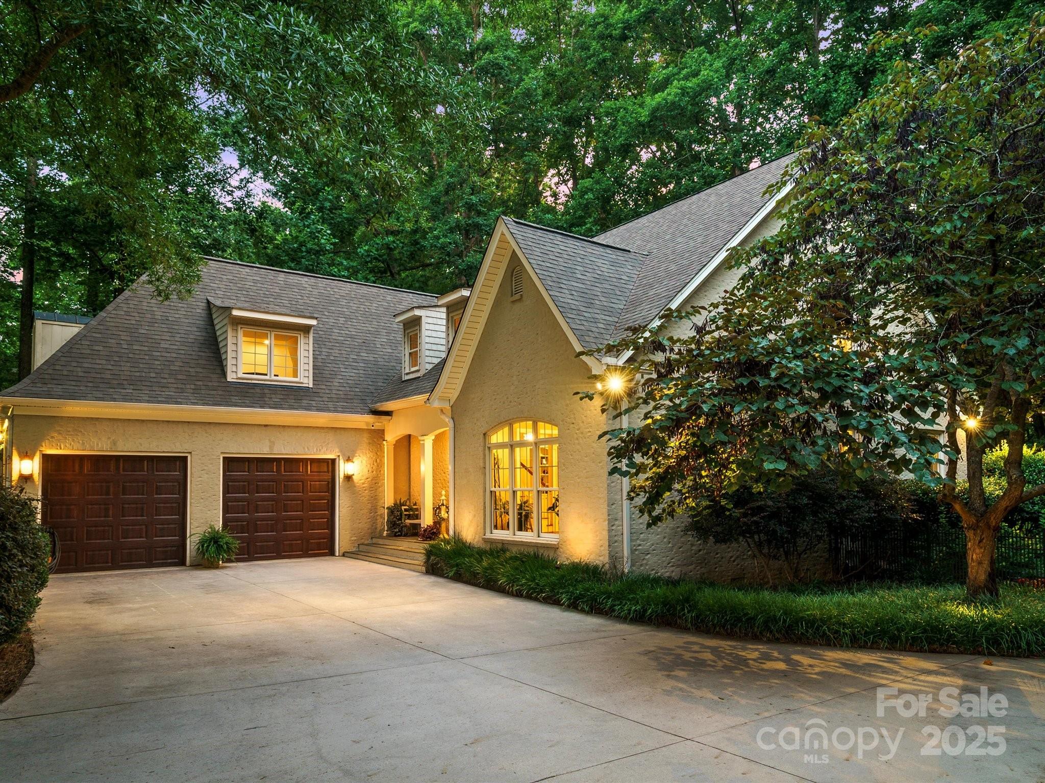 Enjoy your dream retreat, nestled in a lush, wooded oasis offering relaxing privacy & serenity. This architectural gem features a spacious open-concept design, elegant crown molding & hardwood floors. The gourmet kitchen is equipped w/ ss appliances, double ovens, a grand island & breakfast bar...a chef’s paradise. The living area, centered around a charming wood-burning fireplace & flooded w/ soft natural light from expansive windows. The main level master suite boasts a ensuite bathroom & TWO walk-in closets. Step outside to a screened porch, a patio w/ a stone fireplace & built-in natural gas grill, ideal for unforgettable gatherings. With a spacious two-car garage, this cozy larger-than-it-appears haven awaits new owners. Recent upgrades include a new roof, HVAC, & gutter guards (all 2024). Love a pristine yard without the mowing? A acceptable offer includes a Husqvarna Automower & Home warranty. Agent is owner; pre-listing inspection completed. Fall in love—schedule a viewing!
