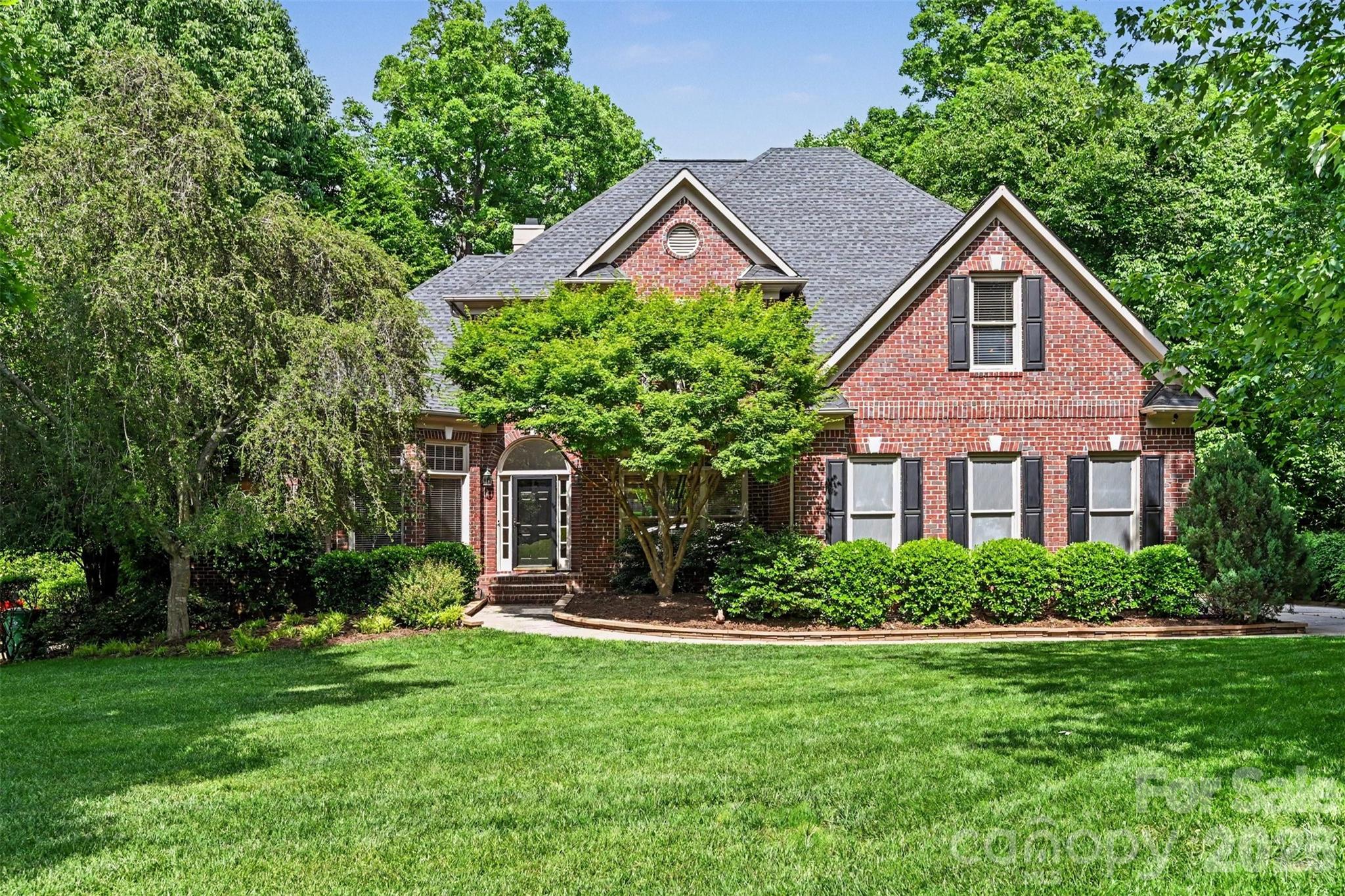 Stunning full-brick home on a beautifully landscaped lot with a private wooded backyard and incredible indoor and outdoor living spaces. This elegant home features soaring ceilings, abundant natural light, hardwood floors, and beautiful custom details throughout. The spacious great room offers vaulted ceilings, built-ins, and a cozy fireplace overlooking the peaceful backyard.

The updated kitchen is perfect for both everyday living and entertaining with granite countertops, custom cabinetry, stainless steel appliances, double wall ovens, gas cooktop, oversized island, and a bright breakfast area surrounded by windows. The luxurious primary suite feels like a private retreat with tray ceilings, a sitting area, and a beautifully renovated spa-like bath featuring dual vanities, a freestanding soaking tub, and oversized walk-in shower.

The lower level adds even more living space with a media room, rec room, additional bedroom(without closet), and full bath—ideal for guests, entertaining, or multi-generational living. There is also plenty of storage space along with dedicated workout and workshop areas.

Additional highlights include a formal dining room, dedicated office space, spacious secondary bedrooms, and an incredible screened porch with vaulted wood ceilings and tranquil wooded views. Meticulously maintained and thoughtfully updated, this home offers the perfect blend of comfort, style, and functionality.   Just steps from The Bowl at Ballantyne, a premier walkable dining and entertainment destination in South Charlotte featuring more than 15 restaurants, the 3,500-seat TD Amp Ballantyne amphitheater, and the scenic Stream Park.