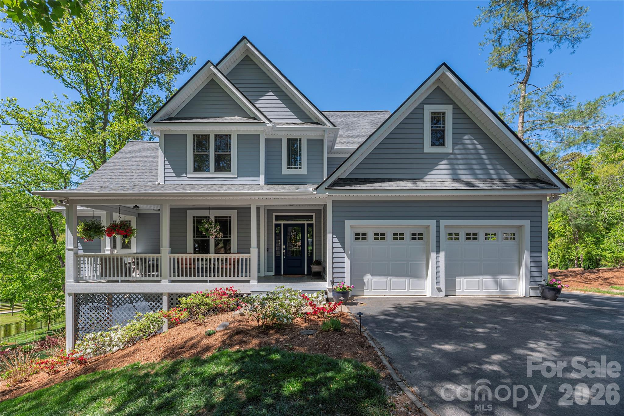 Located on a beautifully landscaped homesite in Duncan Creek Estates, this home offers the perfect blend of comfort and luxury with incredible outdoor living. The light-filled great room welcomes you with soaring ceilings, custom built-ins, hardwood floors, and a stunning floor-to-ceiling stone fireplace. The thoughtfully designed kitchen features Bosch appliances, granite countertops, abundant cabinetry, and an open flow ideal for everyday living and entertaining. The spacious floor plan offers flexible living with multiple gathering spaces, dedicated office space, generous bedrooms, and a large bonus room. The finished lower level provides exceptional versatility with a second kitchen, living space, private bedroom, bathroom and laundry with direct access to the backyard.
Outside, enjoy one of the property's most impressive features—a sprawling stone patio designed for entertaining, complete with gathering spaces, fire pit area, mature landscaping, and beautiful mountain and pastoral views. Relax on the covered front or back porch, host friends outdoors, or simply enjoy the privacy and serenity of this exceptional setting. The garden is in bloom so come check it out today. Conveniently located between Asheville and Hendersonville while offering the peaceful atmosphere of a private mountain retreat.