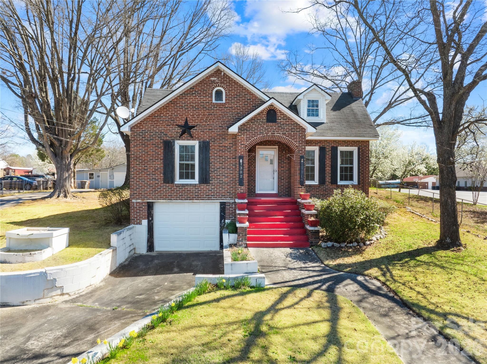Charming Full Brick cottage situated on a spacious .36-acre corner lot in Kannapolis, offering 3 bedrooms, 2 full baths, and 1,915 sq ft with additional basement space and garage storage. This classic home blends timeless character with functional living spaces, featuring a bright living room with fireplace, abundant natural light, and beautiful original architectural details. The main level includes two bedrooms, a full bath, living room, dining room, and kitchen with breakfast area, while the upper level offers a third bedroom, flex space, and full bath, ideal for guests, office, or bonus area. Additional highlights include two fireplaces, split-bedroom layout, basement with laundry hookups, attached garage, detached garage/workshop, and carport providing ample parking and storage. Conveniently located near downtown Kannapolis, shopping, dining, and easy access to I-85 and Concord/Charlotte, this home offers charm, space, and opportunity.