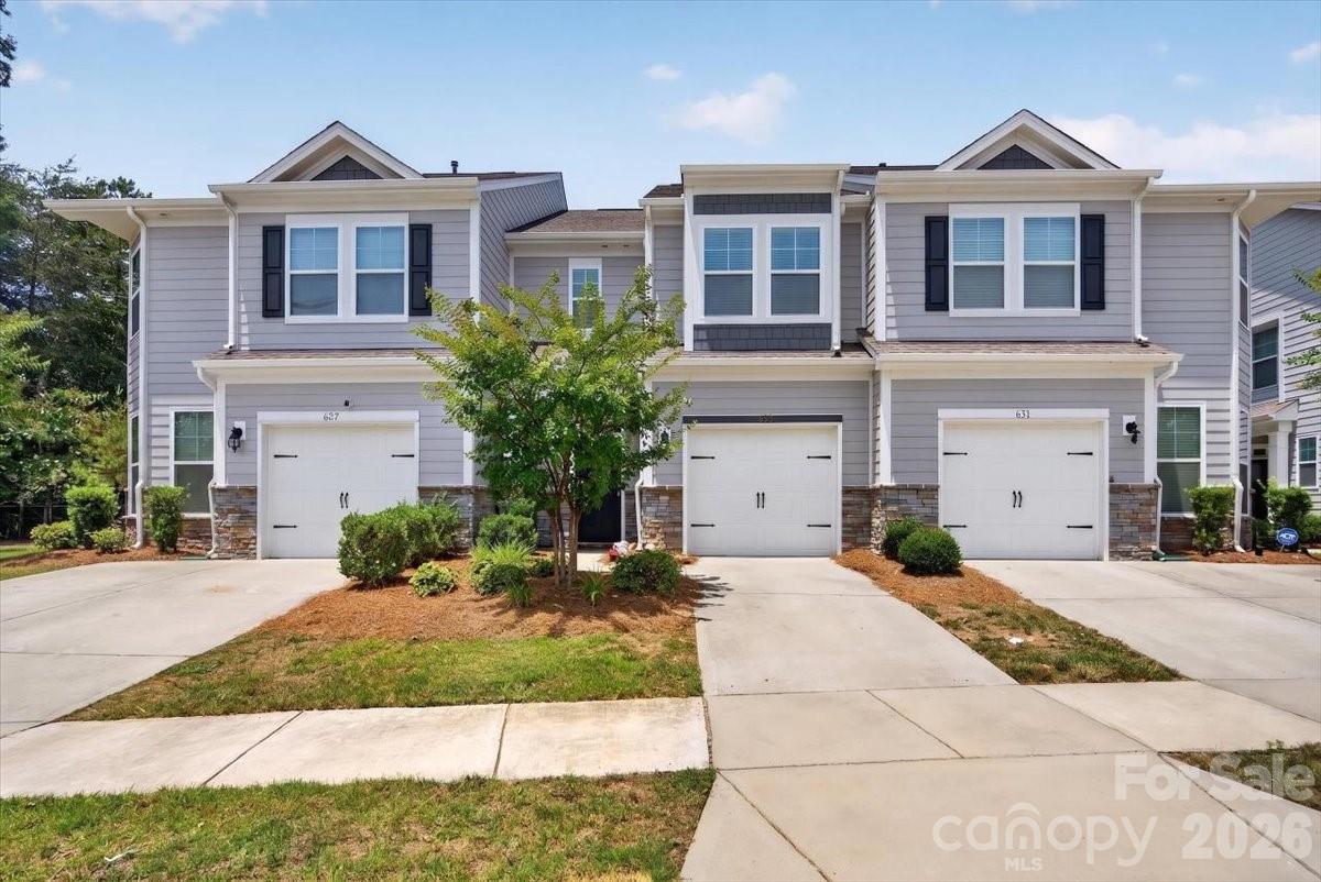 Welcome to 629 Cypress Glen Lane in Lake Wylie, SC — a 3-bedroom, 2.5-bath townhome in the Village at Ivy Ridge that lives and flows like a single-family home. Built in 2021, this 1,765 sq ft move-in ready home sits on a quiet dead-end street in one of Lake Wylie’s most connected and amenity-rich communities — zoned for the popular Oakridge Elementary, Oakridge Middle, and the brand new Lake Wylie High School.

From the moment you walk in, the design details set this home apart. The open-concept main level features a kitchen you’ll actually want to cook in — a 5-burner gas range, an upgrade rarely found in townhomes at this price point — stainless steel appliances, a refrigerator with ice maker, a kitchen island with seating for 3, and a dedicated dining area. Custom light fixtures and designer lighting upgrades throughout the main level create warmth and intention in every room. The open floor plan flows naturally from kitchen to living to dining, making entertaining effortless and everyday living feel expansive.

Step outside to a private patio partially enclosed by fencing with a wooded tree line that provides natural privacy — a quiet retreat for morning coffee, evening unwinding, or weekend gatherings with friends and family.

All three bedrooms are upstairs alongside a dedicated laundry room. The primary suite is a true sanctuary — luxury vinyl plank flooring, a custom walk-in closet with designer built-ins, and a spa-inspired walk-in shower finished with custom tile work and custom pebble flooring that turns your daily routine into a five-star moment. Both secondary bedrooms feature their own custom closets and ceiling fans — every room in this home is thoughtfully finished and completely move-in ready with no updates needed.

The Village at Ivy Ridge is a community that actually feels like one. The HOA handles all lawn maintenance and covers exterior of the home, so your weekends belong to you — and those weekends are full. A dedicated social committee organizes food trucks, poker nights, and seasonal community events throughout the year. Neighbors connect through a private Facebook community group and gather at resort-style amenities including a 24/7 fitness center, outdoor pool with splash pad, pickleball courts, clubhouse, gazebo, picnic area, and a newly updated playground. The townhome is situated on a dead-end street making it an easy & quiet lifestyle for playing outdoors and spending time with friends and family.

Located minutes from the Buster Boyd Bridge for a seamless Charlotte commute and in the highly sought-after Clover School District. Accepts Cash, Conventional, FHA, and VA financing.