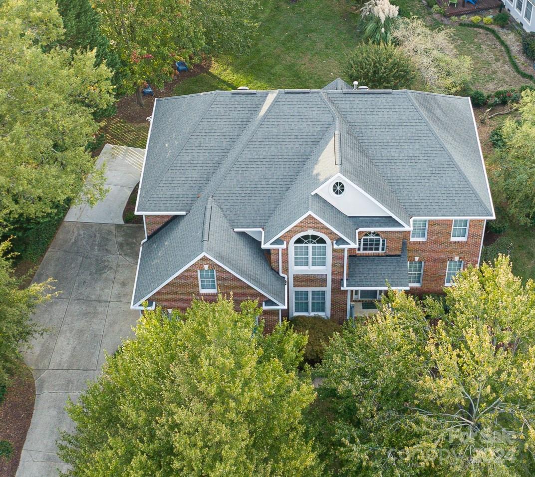 Nestled in the highly sought-after Bailiywyck neighborhood, this full brick 5 bedroom, 3.5-bath home offers an elevated living experience. The open floor plan seamlessly connects the spacious living areas, making it perfect for entertaining. Spacious family room with a fireplace. Transitional formal living & dining room. Kitchen features an island with 5 burner gas stove, double oven and pantry.  Back staircase leading to large bonus room. Primary up w/luxurious bath. The private flat backyard is a retreat of its own, featuring a vaulted screened porch with Easy Breeze windows and tiled flooring and a cozy fire pit, large deck, ideal for year-round enjoyment.  Community stocked pond, teeming with vibrant wildlife. Social Community where Residents can enjoy access to a range of amenities, including playgrounds, pool, tennis courts with pickleball lines. Highly desired Nations Ford High schools. Minutes to Hwy 77, close to restaurants, shopping and easy access to uptown Charlotte.