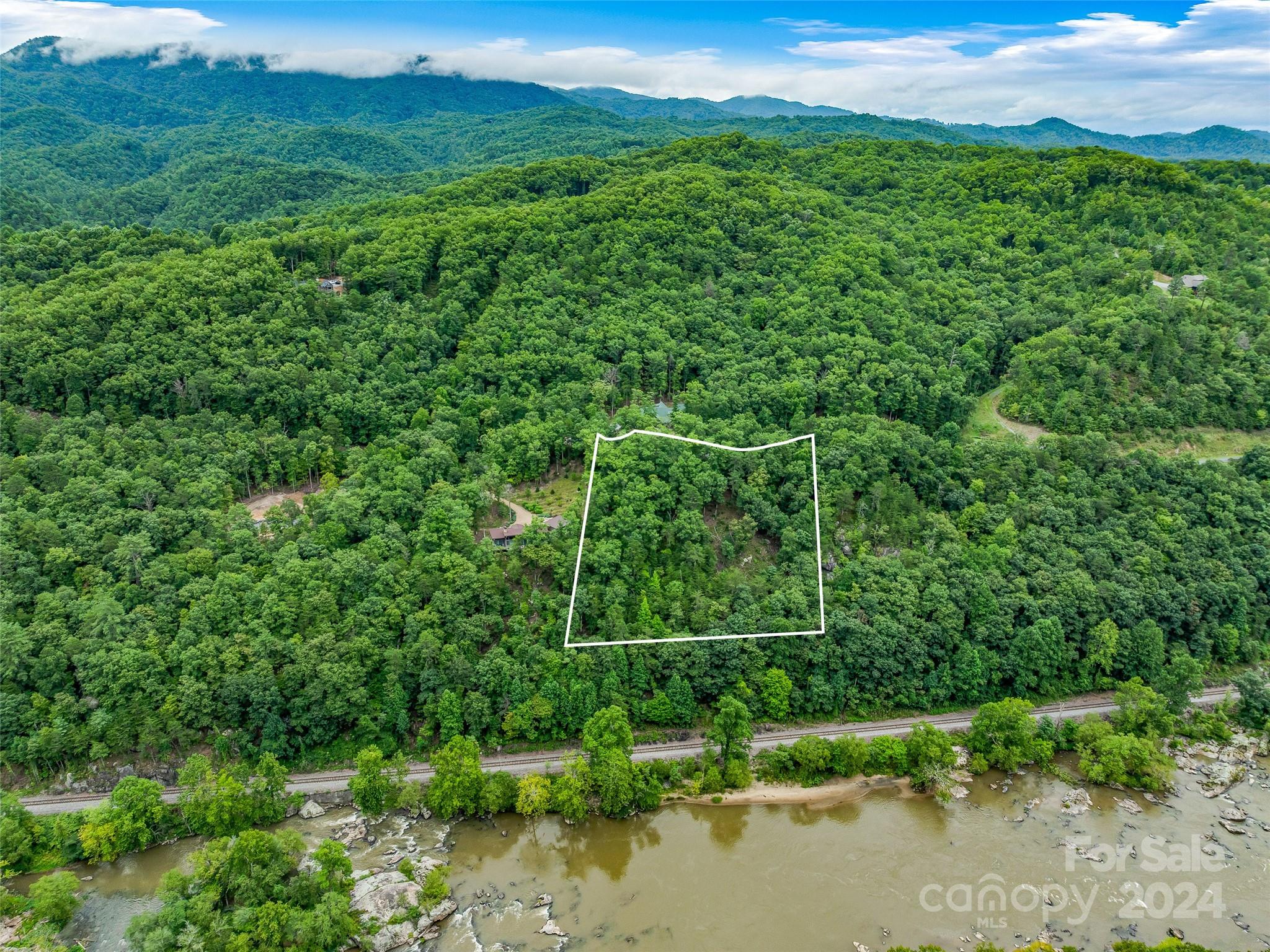 Ever dream of building a home overlooking a rushing river with a mountain view? You can have that
and more at French Broad Crossing, a gated community approximately 30 minutes from Asheville.
Amenities include The River Lodge where you have a Fitness Center, Pool, & Hot Tub. Down the road
is a River Park directly on the mighty French Broad River where you will also find a Tree House
Park. There are also miles of Hiking and ATV Trails. You can build your dream home on this lot and
have a back deck overlooking the river and mountains - what more could you ask for? Come see for
yourself.