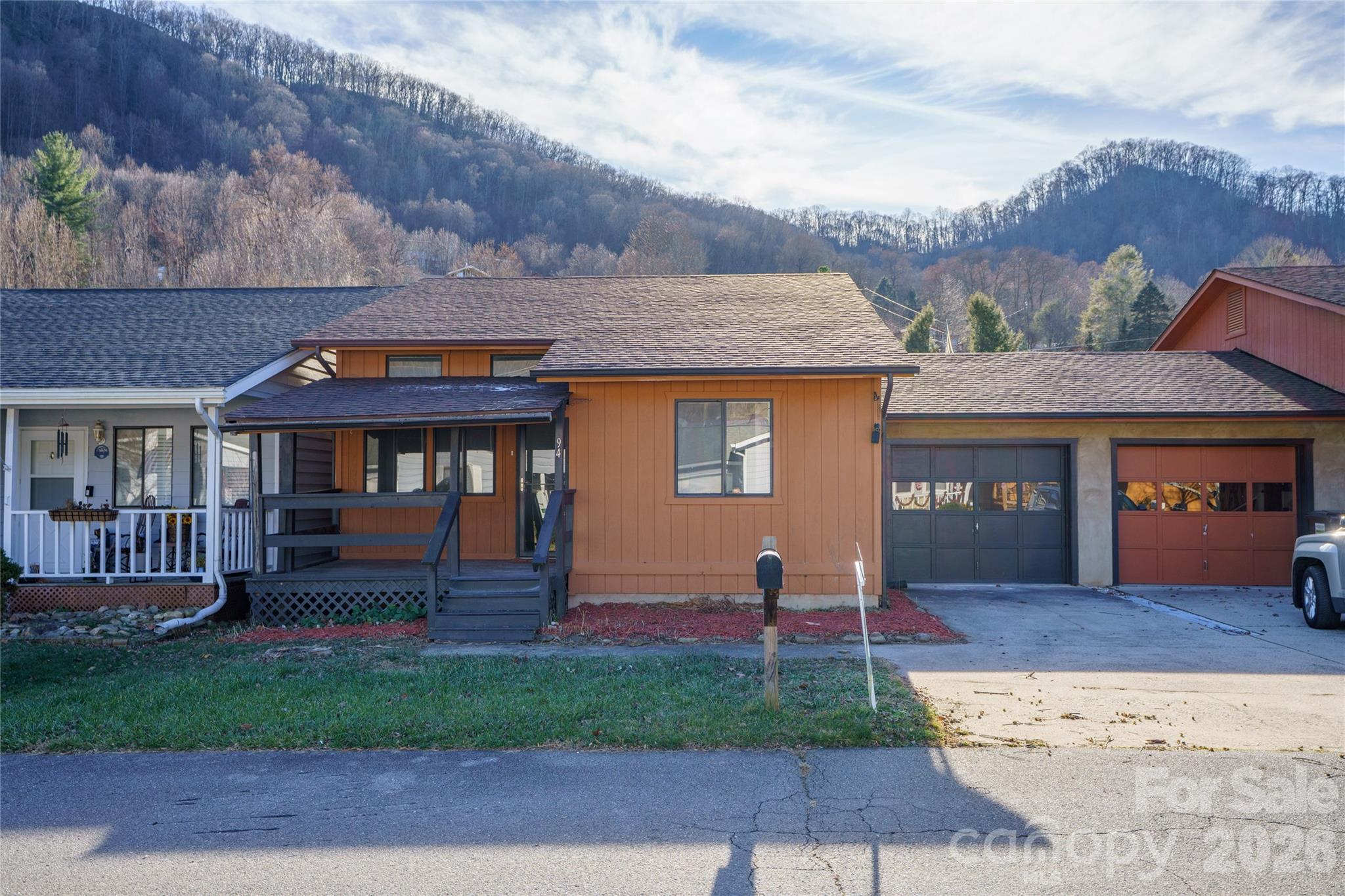 ROOF 2025 • ONE-LEVEL LIVING with GARAGE • LONG-RANGE MOUNTAIN VIEWS • Very Desirable location • WALKABLE MAGGIE VALLEY

Enjoy effortless mountain living in this updated 2BR/2BA one-level home with 1 step to the GARAGE in the heart of Maggie Valley. Fresh paint, roof 2025, smooth 9-ft ceilings (no popcorn!), heated sunroom, gas fireplace, flat paved access, city utilities and low-maintenance living ,No HOA fees— perfect for rentals, retirees, second-home owners, or any buyer seeking comfort without hassle.

Low maintenance. Easy access. Lock-and-leave convenience. Rare heated sunroom with southern exposure and long-range views. Elk frequent the yard. Walk to restaurants, shops, and Festival Grounds on Maggie's popular sidewalks.

Recent updates include a NEW ROOF, fresh interior paint, and smooth 9-foot ceilings (no popcorn) throughout the home. All living spaces are conveniently on one level, including the living room, kitchen, sunroom, 2 bedrooms, 2 full baths, front porch and laundry room —no interior stairs to manage. Just one step to the garage, making it easy with groceries or with inclement weather.

Additional highlights include:
... True one-level living

... Flat, paved year-round access

... Heat pump for heating and AC ... Primary bedroom with ensuite bathroom 

... City water & city sewer. No HOA fees.

... Attached garage (home connected to the neighbor at garage only for added privacy)

... Covered front porch

... Low exterior yard maintenance

... Schedule your showing today. This home is designed for comfort and simplicity.

The home offers a heated sunroom which faces beautiful mountain views and enjoys southern exposure for natural light all day long. The primary bedroom includes an ensuite bathroom and overlooks the backyard with views of both the garden and the mountains.... All living areas are on one level—including the living room, two bedrooms, two full bathrooms, a sunroom, laundry room, and attached one-car garage. The kitchen features stainless steel appliances, a breakfast bar, and a country-style layout that opens to both the living area and the sunroom and where a gas fireplace adds warmth and charm, perfect for cool mountain evenings. The  heated sunroom is a fabulous addition that most homes do not have.

The backyard is small and easy to manage—ideal for someone who wants a touch of outdoor space without hours of lawn care. The elk visit this yard frequently. There’s room for a pet, small garden, or fire pit. The front covered porch offers another spot to relax and enjoy the mountain air.

Flat, paved access makes this home easy to reach in all seasons, with a heat pump for AC and heat, city water and city sewer for added convenience. The home is attached at the garage only, providing privacy while reducing exterior maintenance responsibilities. 

Location is a key advantage: walk to the Maggie Valley Festival Grounds, restaurants, and local shops. A short drive takes you to Waynesville’s historic downtown, the Blue Ridge Parkway, Cherokee Casino, or Asheville’s airport and cultural attractions.

If you’ve been looking for a clean, comfortable mountain home that doesn’t come with a big yard or steep roads, this property checks all the boxes. Easy to live in, easy to lock and leave, and easy to enjoy—schedule your showing today.

One-level homes with views, city utilities, and walkable locations are increasingly rare in Maggie Valley.