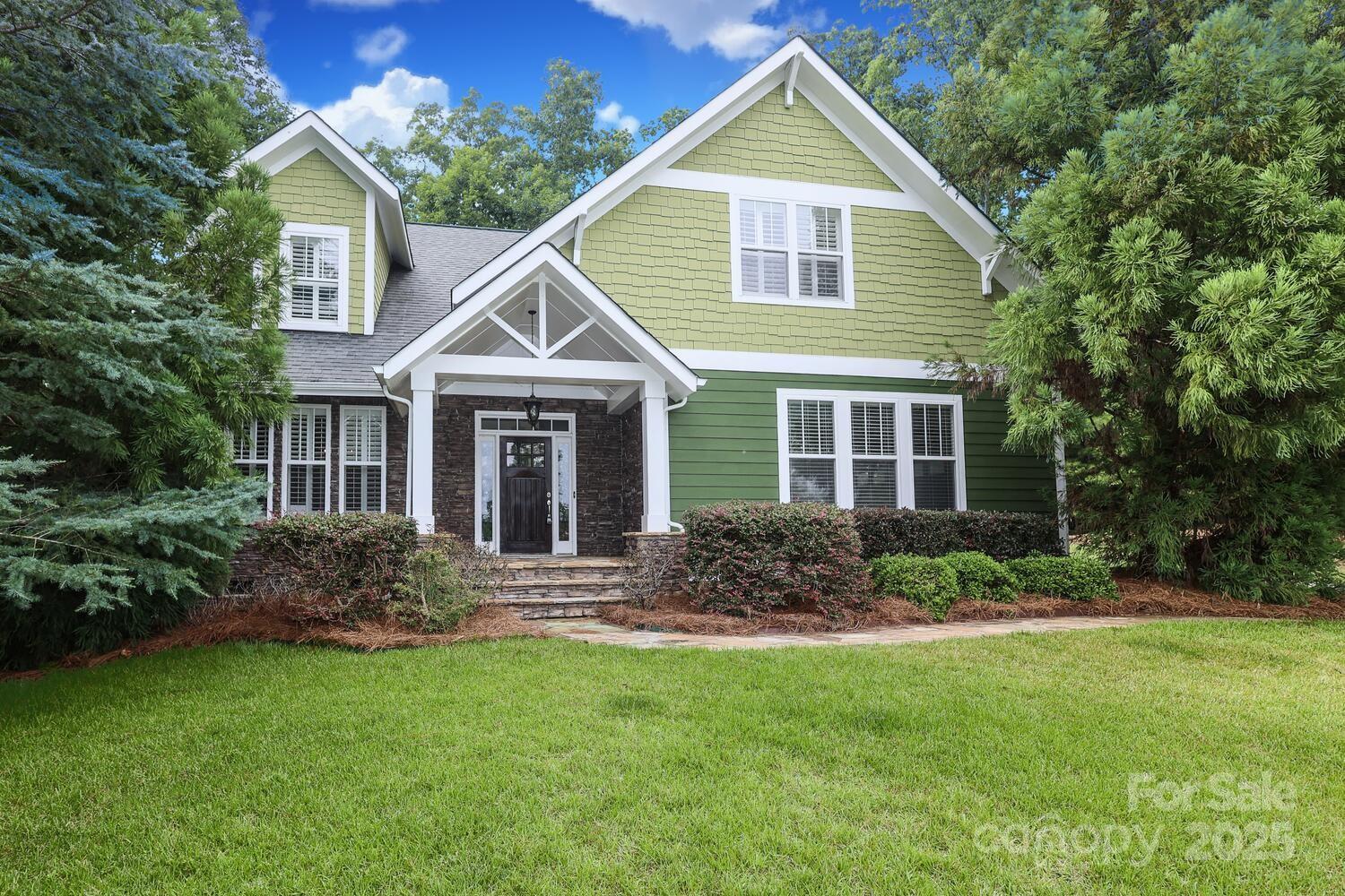 Adorable cul-de-sac well landscaped home with stone front porch; entry foyer; large dining room;  great room w/vaulted ceiling & stone wood burning fireplace; large kitchen w/lots of cabinets (breakfast bar) & breakfast area & large preparation areas (granite countertops).  Enjoy your morning coffee at your breakfast area or move to your screen deck or sit out on your uncovered deck overlooking a serene wooded private fenced backyard (irrigation system); the primary bedroom on main level w/En Suite (garden tub, separate shower & dual vanities; dual walk-in closets). Two car side-load garage and 1 car detached garage with separate storage building. Upper level features 2 or 3 bedrooms (or bonus room) (as well as large closets & walk-in attic (add'l storage).  One full bath on  upper level. Located in the heart of Lake Wylie and in the award winning Clover School District. Lake Forest includes launch for your kayak. See tour: http://catch-light-studio.seehouseat.com/2334795?idx=1