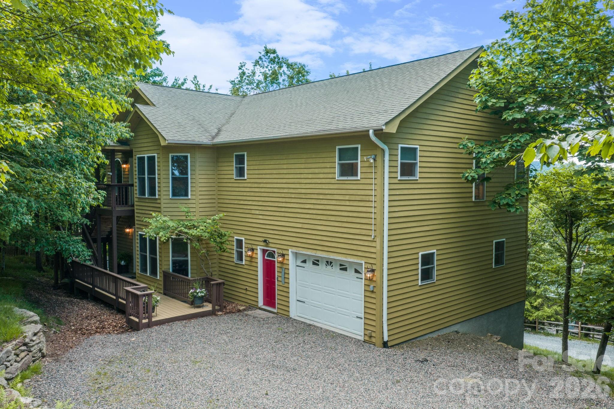 Priced with investors in mind, 117 Pinnacle Ridge Road is an established short-term rental property perched just shy of 5,000 feet on Beech Mountain. Sold fully furnished and ready to rent, this spacious mountain home offers three en suite bedrooms plus a bunk room, comfortably accommodating up to 10 guests. The flexible layout features separate upper and lower-level entrances, along with interior access through the oversized two-car garage—convenient for larger groups, multi-generational stays, and seasonal mountain weather. Large storage closets throughout provide excellent owner and guest functionality. Recent improvements include new carpet throughout, re-tiled bathrooms, and fresh exterior stain. The back deck showcases long-range mountain views and cool summer breezes, creating the perfect setting for outdoor relaxation. Located minutes from Beech Mountain Club and Beech Mountain Resort, owners and guests can enjoy golf, tennis, pickleball, hiking, biking, fishing, skiing, snowboarding, live music, dining, shopping, summer camps, and children’s activities. Beech Mountain Club membership is not currently in place, but the property qualifies for membership. A compelling option for a summer mountain retreat, flexible second home, or turnkey short-term rental investment.