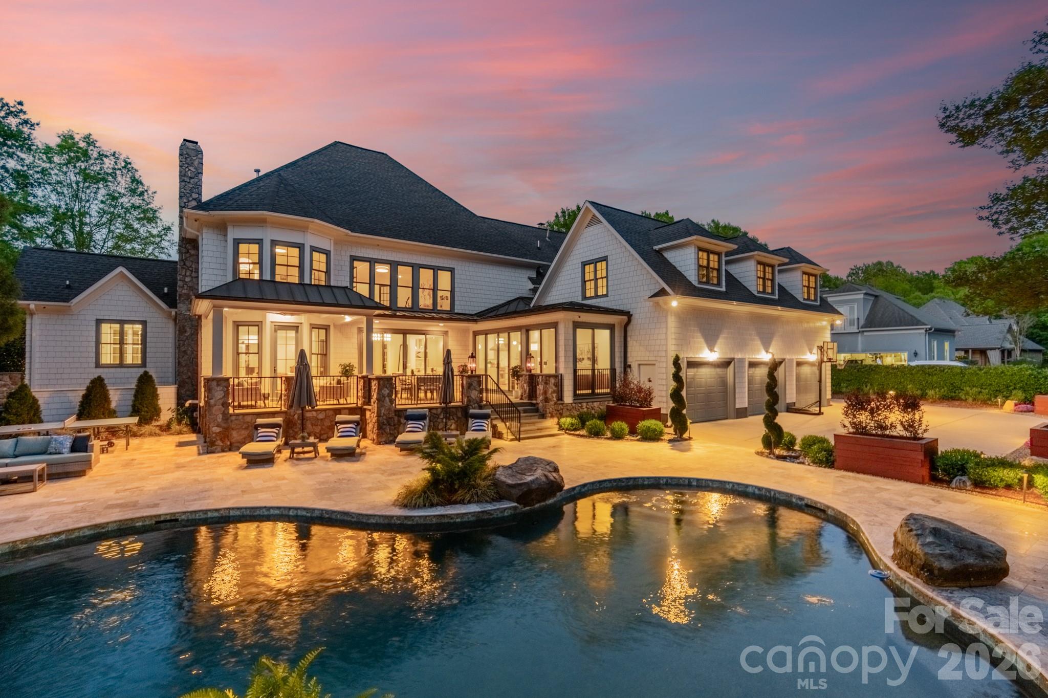 Welcome to this completely reimagined SouthPark residence, where thoughtful design and elevated material selections come together to create a truly distinctive living experience. Completed between 2021 and 2022, the home reflects a comprehensive renovation that blends modern living with the character of one of Charlotte’s most established and walkable neighborhoods.

Spanning more than 6,300 square feet, the home offers a seamless flow of space, where each room feels intentional and connected. Five-inch European white oak flooring extends throughout, including staircases, complemented by solid-core doors in a custom electric blue finish. Designer lighting, sourced through New York design channels, adds a curated layer of warmth and dimension.

Natural stone is featured throughout as both a design element and focal point, with exotic quartzite showcased in the primary suite, main-level den and select bath and vanity spaces. The primary suite offers a private retreat with a bath finished in floor-to-ceiling Italian porcelain tile and a custom dressing room with center island.

The kitchen is designed to balance performance and style, anchored by Fantasy White honed quartzite surfaces, including a waterfall island and full-height backsplash. A professional-grade appliance suite, custom cabinetry and dual laundry areas support both everyday living and entertaining.

Gathering spaces throughout the home offer flexibility and comfort, including a main-level family room with Saratoga Black leathered quartzite framing the fireplace, coffered ceiling detailing and integrated audio. The third-floor entertainment level creates a dedicated media experience with a 120-inch screen, Epson projector, Apple TV integration and a HEOS multi-zone sound system.

Expansive sliding doors open to a redesigned outdoor setting where bluestone terraces and an extended travertine patio frame the pool and spa. Landscape lighting, irrigation systems and raised garden beds enhance both usability and presentation, while architectural updates such as cedar shake-style siding, Belgian paver driveway accents, gas lanterns and gated entry complete the property.

Located in the heart of SouthPark, this home offers a rare opportunity to enjoy a fully renovated residence with a level of design and finish more commonly found in larger metropolitan markets.