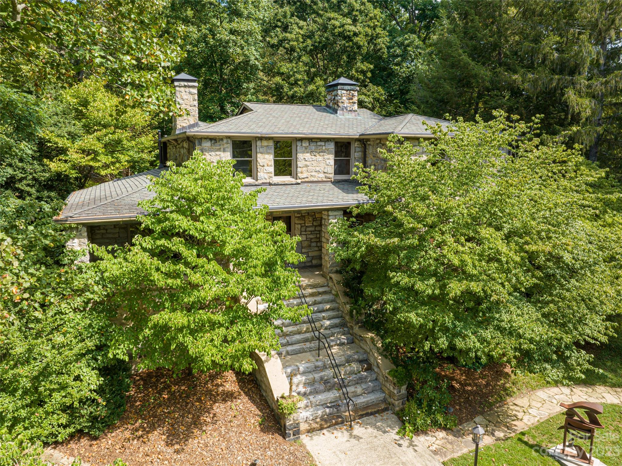 Introducing the Kimberly House where true craftsmanship meets history and elegance. Built in 1915; this rare home is comprised mostly of granite from the family's quarry. The same masons and carpenters who built the Grove Park Inn also built the Kimberly House. Upon entering the home, you will see the built in curios cabinets in the exposed granite. Rooms that contain 3 of the 7 fireplaces in the house are arrayed along the hall, taking one to the chef's kitchen that has been beautifully updated. This exquisite historic home seamlessly blends the grandeur of the past with modern comforts. Discover the epitome of space and versatility in this magnificent five-bedroom home that offers seasonal mountain and city views. Nestled in a serene oasis, this property provides a secluded escape while being just 5 minutes from Downtown Asheville and walking distance to the Grove Park Inn. Situated on an impressively sized lot of 1.15 acres that is mostly fenced in and has two gated entrances.