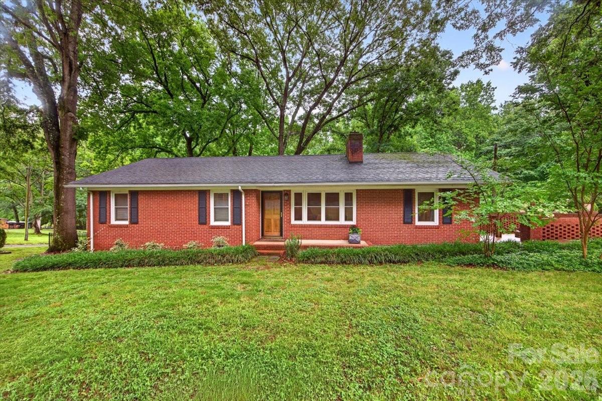 Completely renovated ranch on 1.07 acres approximately one mile from downtown Waxhaw! This move-in-ready home features refinished hardwood floors throughout, fresh neutral paint, and stylish updates at every turn. A welcoming front living room offers flexibility as a family room or formal dining space. The beautifully renovated kitchen showcases new cabinetry, countertops, stainless steel appliances, upgraded lighting, and modern hardware. Just off the kitchen, a spacious second living area provides additional gathering space and convenient side entry access. The oversized laundry room includes built-in storage for added functionality. The home offers two bedrooms and two fully remodeled bathrooms, including a spacious primary suite with a walk-in closet. Outside, enjoy a private, mature, fully fenced backyard with endless possibilities. Relax on the oversized deck, gather around the fire pit, or take advantage of the impressive outdoor amenities, including a fully equipped workshop (1,200 sqft per previous owner), detached garage, and additional storage shed. Enjoy the convenience of being minutes from downtown Waxhaw’s shops, restaurants, and entertainment while still enjoying the privacy and tranquility of country-style living.