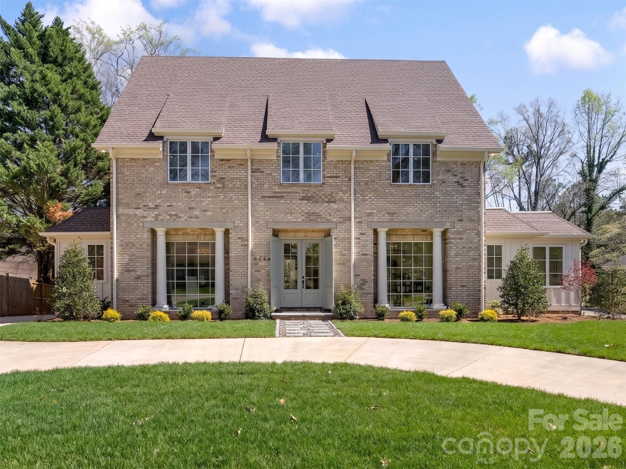 Great opportunity for custom new construction built by DuBose Custom Homes. This home features high ceilings, hardwood floors, gracious formal areas with large windows and abundant natural light. Modern luxury—crafted with timeless elegance and an eye for elevated architectural detail. With more than 5,800 square feet, 5 bedrooms, and 6.5 baths, this home delivers the scale, sophistication, and lifestyle today’s discerning buyer expects. The moment you step inside, the home’s thoughtful design becomes clear. The main level offers flexible bedroom suite options, perfect for guests, work, or private retreat spaces. The gourmet kitchen is a showstopper, featuring paneled cabinetry, a full-size wine tower, and an oversized island designed for both everyday living and high-end entertaining. The wet bar, wrapped in full slab marble and finished with sleek metal cabinetry, elevates the home’s modern aesthetic. Primary suite features vaulted ceilings, luxury spa bath and 2 separate closets. Three additional ensuite bedrooms provide comfort and privacy alike.
Outside, the covered rear porch with fireplace creates a seamless extension of the living space, perfect for year-round gatherings. The detached two car garage enhances the home’s stately presence, while the .37 acre lot offers room to design your dream outdoor oasis. The full walkout lower level adds another layer of luxury and flexibility, featuring its own private entrance, covered patio with fireplace, finished rec room/bedroom, walk in closet, full bath, and thoughtfully designed entertainment space. It’s an ideal setup for multigenerational living, a private guest suite, or a sophisticated gathering space. Set in one of Charlotte’s most established communities, this home offers unmatched access to SouthPark or Uptown, New construction of this caliber—within a neighborhood of this pedigree—is a rare opportunity. This is luxury living at its most effortless and refined.