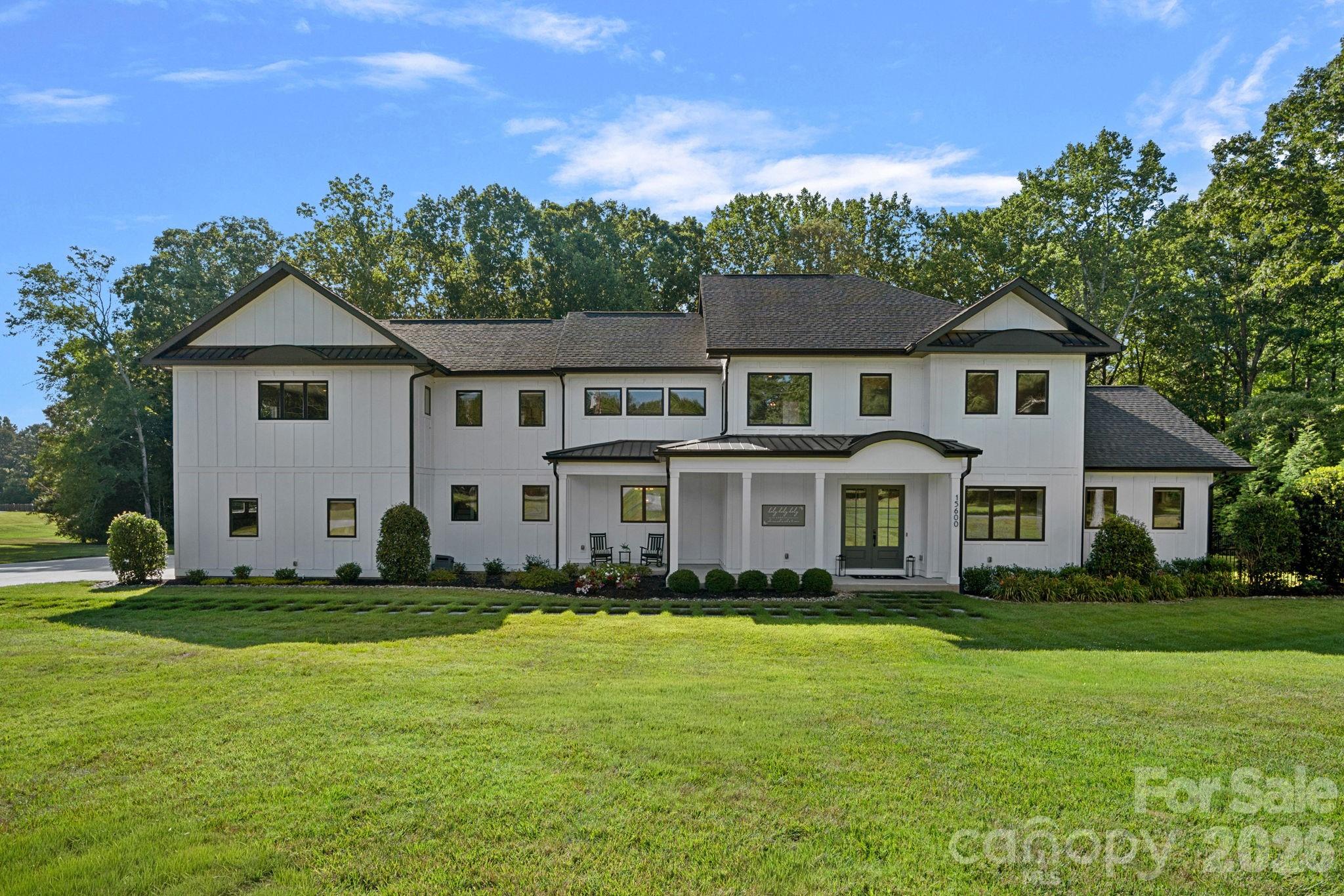 Stunning farmhouse situated on nearly 3 private acres, offering luxury and comfort throughout. This exceptional custom-built estate offers 5 bedrooms, 4.5 bathrooms, and an incredible floor plan designed for both everyday living and unforgettable entertaining.

The chef’s kitchen is truly the heart of the home, featuring a massive quartz island, farmhouse sink, 6-burner gas range with griddle, double ovens, walk-in pantry, two built-in beverage refrigerators, and endless custom cabinetry. The open-concept design flows seamlessly into the main living areas, creating an inviting space filled with natural light and beautiful views of the backyard retreat.

The main level also features a private office, a custom-built dog room, a stunning primary suite, and a spacious laundry room conveniently located off the garage. The luxurious owner’s retreat includes dual walk-in closets and a spa-inspired bath with an oversized walk-in shower and freestanding soaking tub.

Upstairs, two separate staircases lead to the second level featuring a private mother-in-law suite complete with a full bath. An expansive bonus room, dedicated exercise room, three additional bedrooms, and two full bathrooms provide abundant space for family and guests.

Step outside and discover your own private resort. The expansive heated saltwater pool and spa are surrounded by gorgeous travertine decking and overlook a sprawling, flat backyard. Enjoy year-round outdoor living on the oversized TimberTech deck or relax on the expansive screened porch featuring a gas log fireplace and peaceful views of the surrounding property.

Additional luxury features include a sealed crawlspace, LED exterior lighting, oversized garage with dog wash station, premium finishes throughout, and thoughtful custom details around every corner.

This is more than a home—it’s a private estate designed for the way you want to live.