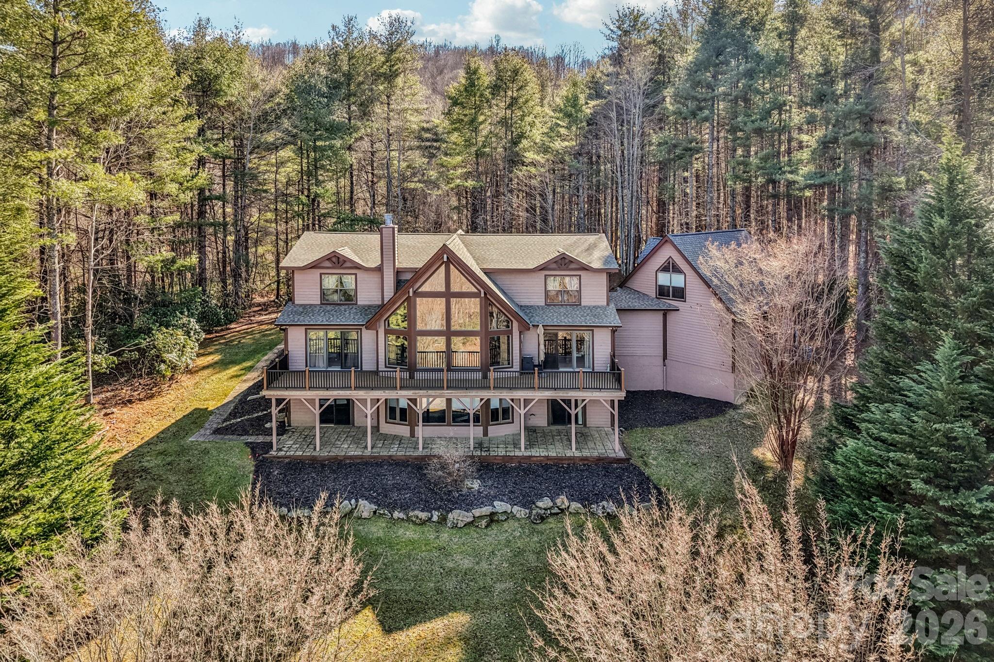 Outstanding mountain retreat in Eagle Lake offering rare value, exceptional condition, and breathtaking year-round views of the Blue Ridge Mountains —just under 15 minutes to downtown Brevard, NC, where you’ll enjoy dining, shopping, art galleries, the renowned Brevard Music Center, and more.

Set on 2.77 private acres, this 4BR/4.5BA home delivers the perfect blend of space, comfort, and turnkey peace of mind—ideal for full-time living or a luxurious getaway. Grand yet welcoming, the home pairs expansive indoor and outdoor living spaces with everyday comfort and ease.

The dramatic great room showcases a stunning 7’ stone fireplace and flows seamlessly into the chef’s kitchen and dining area, all looking out to the lovely open yard and mountain views. The main-level owner’s suite opens to the spacious deck, while every bedroom features a walk-in closet and custom finishes. The lower-level entertainer’s retreat offers a spacious rec room and a showstopping Cherrywood bar with stained glass—perfect for unforgettable gatherings. 

Eagle Lake is anchored by a pristine 32-acre lake perfect for fishing, boating, swimming and beach lounging. Other shared amenities include a playground, boat racks and a large, open green space. Located near Pisgah National Forest, Dupont State Forest and the Blue Ridge Parkway, you'll find a high quality and well-maintained home in a beautiful mountain setting. Private showings by appointment only. Roof and most major systems have been replaced/updated. Please contact agent for a list of upgrades and features.