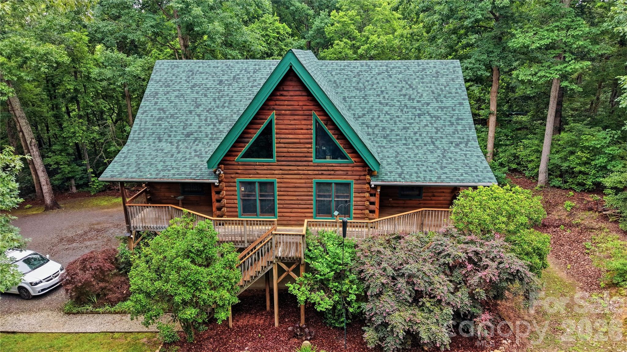 Escape to this beautiful Log Cabin home at 532 Mountain Oak Lane. Tucked away on nearly 5 private acres and located at the very end of a quiet, peaceful cul-de-sac. Enjoy peace of mind with no through traffic that offers a safe and serene environment. Located 2 miles from Crowders Mountain State Park!
This charming 4-bedroom, 3.5-bath log home offers the perfect blend of rustic tranquility and modern convenience. From the moment you step inside, the main level captivates you with its soaring ceilings, exposed log beams, and a bright, open-concept design.
Featuring 9’ ceilings and 12' cathedral ceilings in bedroom and gorgeous tongue-and-groove flooring upstairs that serves as the ceiling for the main living space below. Two bedrooms on the main level including the primary suite and two additional bedrooms upstairs—each with its own private full bath. Built with classic log construction, the home naturally offers superior insulation for year-round energy efficiency and comfort.
The unfinished basement is a blank canvas, perfect for a home business, gym, or extra living quarters. The seller even includes bamboo cork flooring that could be used to update the upper levels.
The property offers peaceful country living with ample room to garden, explore, or relax. An on-site 24' x 52' commercial greenhouse, equipped with both heating and air conditioning, provides great potential for hobbyists or entrepreneurs; please note that the greenhouse can be removed if preferred.
A backup generator offers some electrical amenities during outages.
It’s a lifestyle retreat just minutes from town.