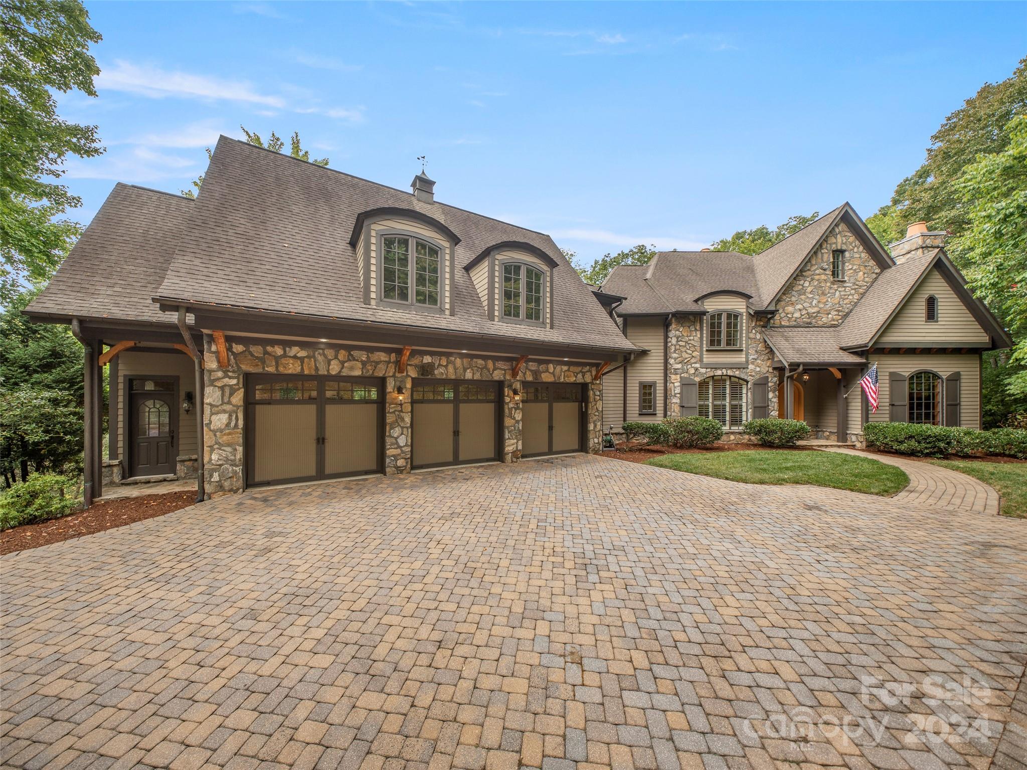 Perched on a knoll surrounded by mature hardwoods on a gorgeous 1.32-acre forested setting, this spacious yet cozy 7,129 SF home offers the best of Western North Carolina in the only gated golf community in Asheville, The Cliffs at Walnut Cove!  Located only a few hundred yards from the Jack Nicklaus Signature Golf Course and the Cliffs' Tavern, enjoy casual and fine dining; or gather with friends at one of the many world-class community amenities, including walking trails, tennis courts, and a state-of-the-art Wellness Center. Sporting a home theater, 2,000+ bottle wine cellar and mother-in-law suite with private access, this stunning home offers the perfect place to live and entertain. Five beautifully appointed bedrooms, with 5 full-baths and 2 half-baths, offers a unique opportunity in the Cliffs at only $358/SF. Membership is available that offers access to golf at all 7 Cliffs’ courses. This spacious mountain home is a perfect match for someone that wants the best of all worlds!
