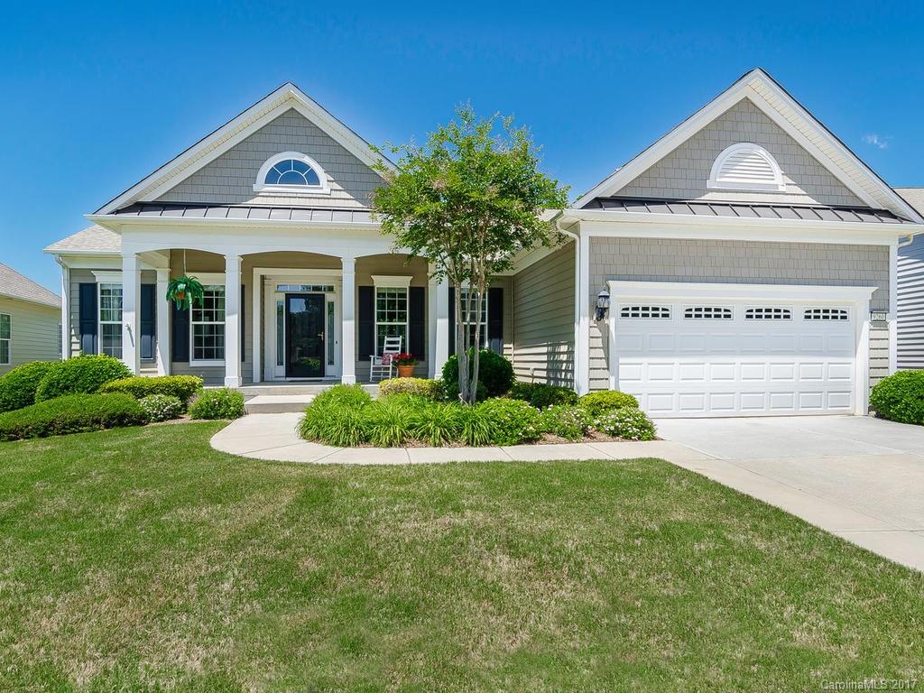 Gorgeous Manor Collection, Bluffton Cottage model w/bright, airy open floor plan, overlooks beautiful wooded area. Pretty gourmet kitchen w/granite countertops & pullouts. Built-ins in Great Room. Spacious finished basement w/ built-in bar, craft room, big workshop, lots of walk-in storage. Tranquil patio surrounded w/professional landscaping. In-ground irrigation. Inside & out it’s perfect for relaxing or entertaining! Superb location, walk to amenities & shopping. 55+ Active Adult Community.