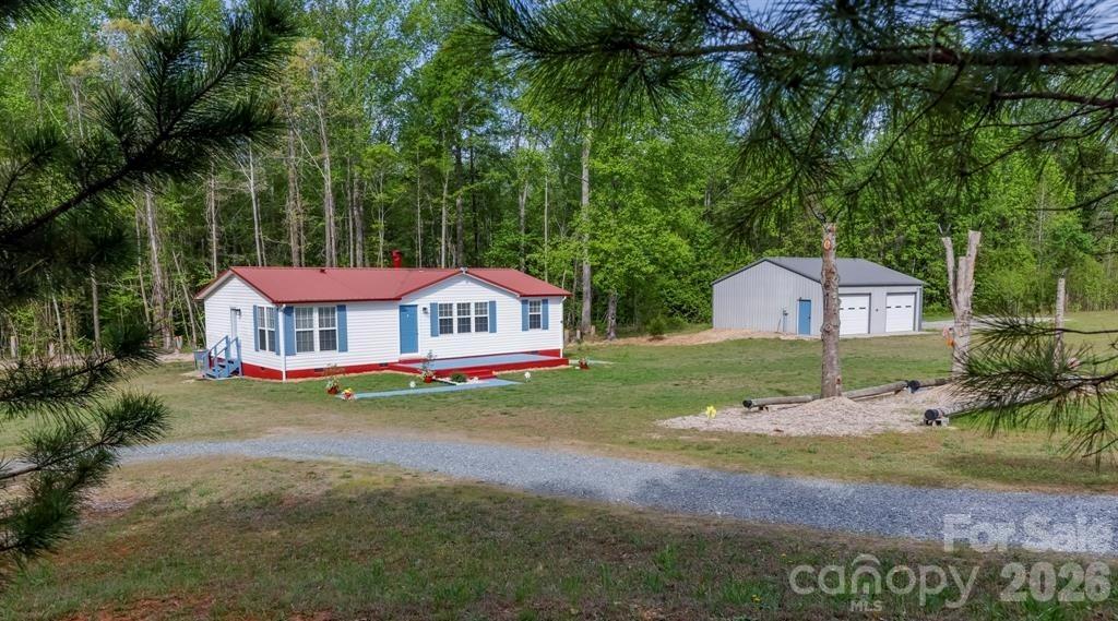 Back on market (buyer contingency fell through). - Welcome to your own private creekside homestead—a rare opportunity to own a fully updated home on 5.37 acres across two parcels, offering the perfect blend of comfort, functionality, and outdoor lifestyle.

Tucked away in a peaceful rural setting, this property immediately sets itself apart with a bold, flowing creek complete with a dedicated picnic and play area—an ideal space for relaxing, entertaining, or simply enjoying the natural surroundings. Much of the outdoor space is illuminated with solar lights for evening enjoyment and playtime.  Meandering walking trails and established fruit trees enhance the land, creating a true homestead experience.

The home has been thoughtfully and extensively updated, featuring a updated kitchen and bathrooms with high-end fixtures, new flooring throughout, fresh paint, and updated ceiling fans—delivering a clean, modern, move-in-ready interior.

A standout feature is the 900 sq ft insulated metal workshop/garage, fully equipped with electricity, and a large air compressor—perfect for hobbyists, contractors, or anyone needing a versatile, self-contained workspace.

The inclusion of two separate parcels (PINs 1623769 & 1623771) adds significant value and flexibility, offering potential for an additional homesite, resale, or long-term investment.

Whether you're looking for a mini-farm, private retreat, or functional live/work property, this one delivers a unique combination of upgrades, usable land, and lifestyle features that are hard to find in today’s market.