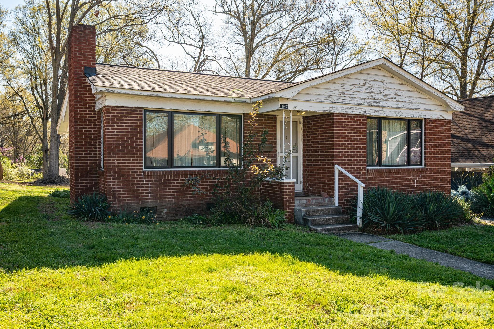 Nestled in the heart of Charlotte’s highly sought-after Plaza Midwood neighborhood, this charming brick bungalow at 1642 Hawthorne Lane offers the perfect blend of character, location, and opportunity. Built in 1959, this cozy two-bedroom, one-bathroom home features approximately 880 square feet of living space and sits on a generous, deep lot of .239 acres.

Inside, you’ll find beautiful hardwood floors that add warmth and timeless appeal, along with updated windows (2020), that bring in an abundance of natural light. The classic brick exterior enhances the home’s curb appeal, while the functional layout provides comfortable living with potential to personalize or expand.  Key Updates- HVAC and roof 2017, Bathroom renovation 2020. A comrehensive list of all completed updates available in property documents.

The oversized lot is a rare find in this area, offering endless possibilities—whether you’re looking to create your dream outdoor space, add square footage, or explore redevelopment potential.

Located just minutes from Uptown Charlotte and within close proximity to local parks, as well as the vibrant dining, shopping, and nightlife scene that defines Plaza Midwood, this property combines urban convenience with neighborhood charm.