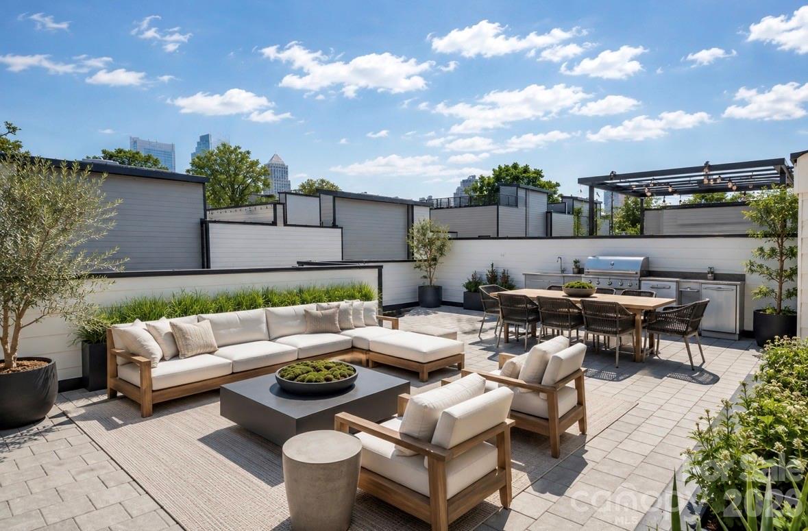 Experience the best of Uptown living at Luxity Terraces, an exceptional end residence in Charlotte's sought-after Third Ward. Offering over 3,700 square feet of thoughtfully designed living space, this move-in-ready home features 3 spacious bedrooms, 3 full baths, a stylish powder room, an attached two-car garage, and a spectacular private rooftop terrace with sweeping views of the Charlotte skyline. Designed for effortless living and entertaining, the open floor plan is enhanced by soaring 10-foot ceilings, abundant natural light, and expansive windows overlooking picturesque Frazier Park—a rare combination of privacy and green space in the heart of Uptown. Rich white oak hardwood floors extend throughout the main and second levels, while polished concrete floors on the lower level add contemporary character. The chef's kitchen showcases quartz countertops, custom cabinetry, stainless steel appliances, a gas range with vent hood, and a generous center island. Freshly painted throughout in 2026, the home is truly move-in ready.Enjoy one of Charlotte's most walkable neighborhoods. Just moments away are Bank of America Stadium, home of the Carolina Panthers and Charlotte FC, Truist Field, Spectrum Center, Romare Bearden Park, Frazier Park, Irwin Creek Greenway, and Uptown's renowned restaurants, theaters, museums, and entertainment. Harris Teeter, CVS, the Blumenthal Performing Arts Center, Discovery Place, and the new Main Library are all within easy walking distance.
The rooftop terrace is an extraordinary extension of the home—perfect for morning coffee, evening cocktails, or entertaining against the backdrop of Charlotte's sparkling skyline. The professionally managed HOA includes water and sewer, exterior building maintenance, common areas, termite and pest control, making for an easy lock-and-leave lifestyle.Rarely does an Uptown residence combine this level of space, privacy, park views, outdoor living, and walkability. Whether you're looking for an elegant primary residence or a sophisticated city retreat, this home offers a lifestyle that is difficult to replicate in Charlotte.