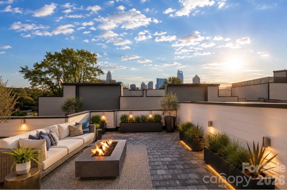 Ultimate Uptown living at its finest at Luxity Terraces in Charlotte’s highly desirable Third Ward. This move-in-ready private END residence features 3 spacious bedrooms, 3 full bathrooms, lovely powder room, and a private two-car garage — a rare Uptown advantage. The home’s hardwood floors flow seamlessly through the kitchen, living, dining, and hallways, while 10-foot ceilings enhance the open, light-filled layout. The kitchen and full baths are appointed with quartz countertops, custom cabinetry, and stainless steel appliances, combining sophistication and functionality, and full baths feature tiled floors and showers with the powder room accented in warm hardwood. A private rooftop terrace provides sweeping Uptown skyline views, offering the perfect setting for entertaining or relaxing above the city. Expansive windows frame serene views of Frazier Park, creating a rare sense of privacy and tranquility in the heart of the city. Just steps from Charlotte’s premier dining, cultural attractions, and professional sports venues, this home delivers the ideal balance of vibrant city life and peaceful retreat. With its exceptional finishes, thoughtful design, generous scale, and unbeatable location, opportunities like this are rare — a home that offers both elevated lifestyle and enduring value. Homes of this caliber attract immediate attention; act now to secure one of Uptown’s most remarkable residences. FRESHLY PAINTED INTERIOR 2026. Water and sewer included