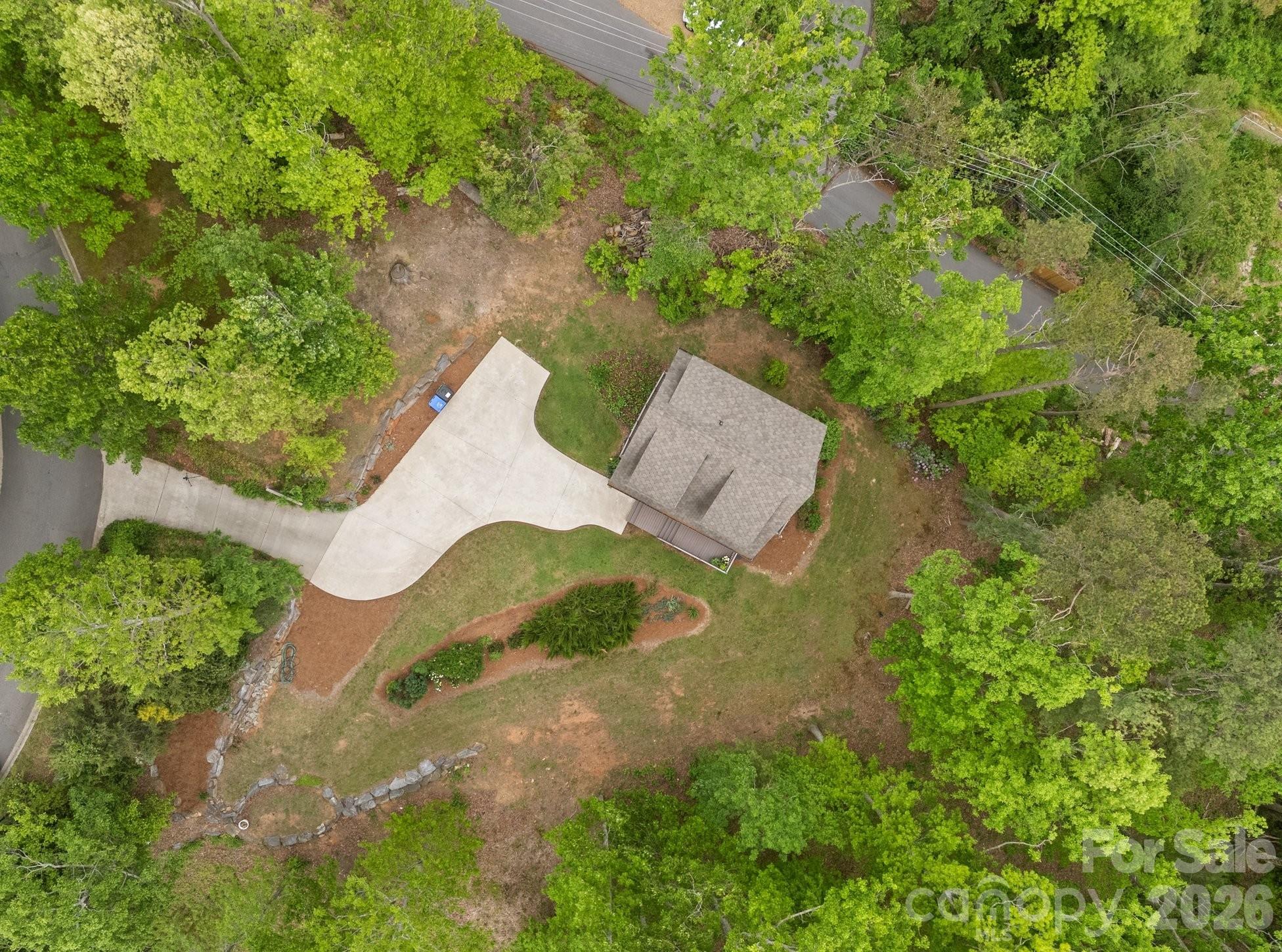 Privacy in the heart of Asheville with mountain views. Build your dream home in this lovely mountain setting on 1.81 acres with a magical guest house already in place.  Located 1.5 miles between downtown and Biltmore Village, and less than 1/2 mile to Mission Hospital. Wake up to see the sunrise and enjoy sunset in the evenings having cocktails with family and friends from the 180 degree views on the property. Immediate access to hiking up Beaucatcher Mountain, or connect to the greenway leading into downtown or McCormick Field. Your own private, mountain retreat right in the city. Gently-sloping build site. Concrete driveway, city water and sewer.
